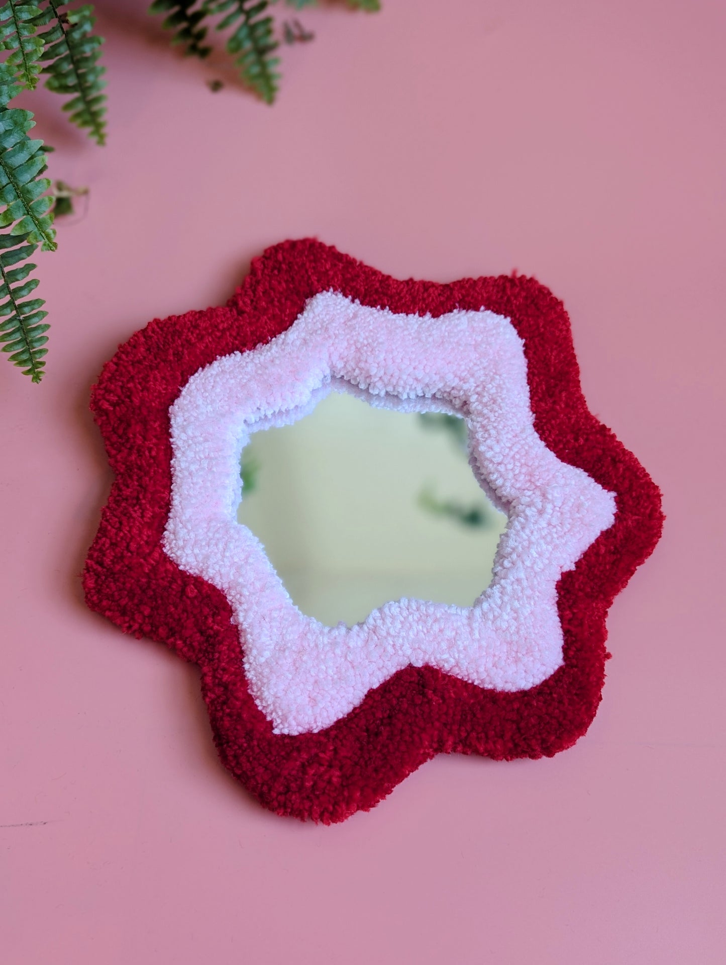 Bright red and pink coloured wavy pattern tufted yarn mirror
