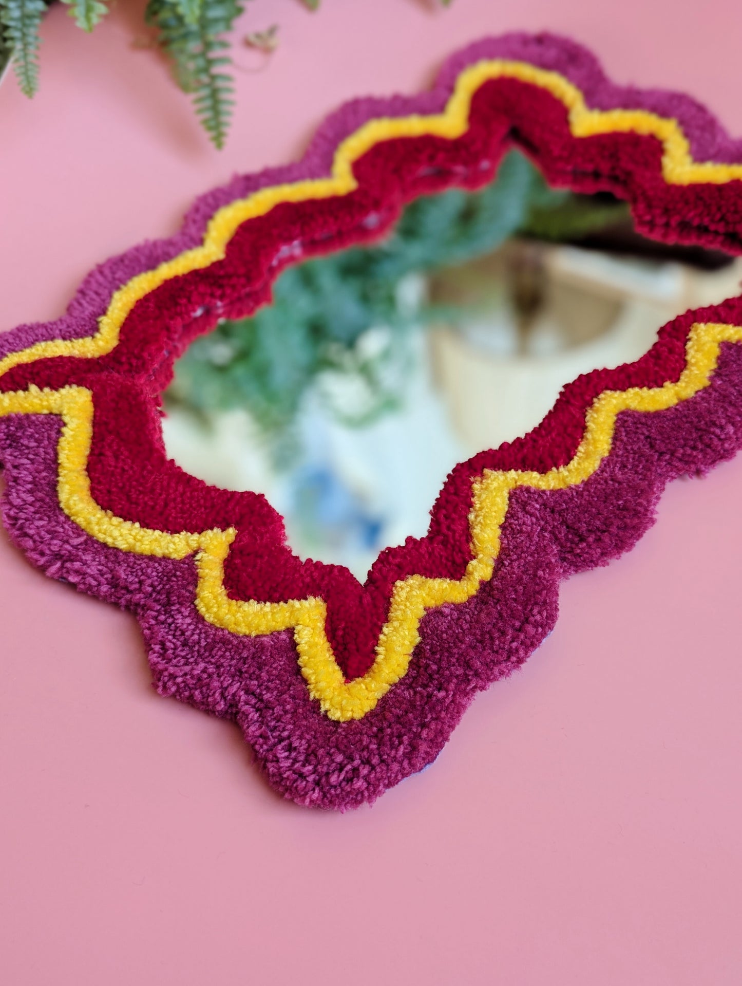 Pink, yellow and red coloured wavy pattern tufted yarn mirror