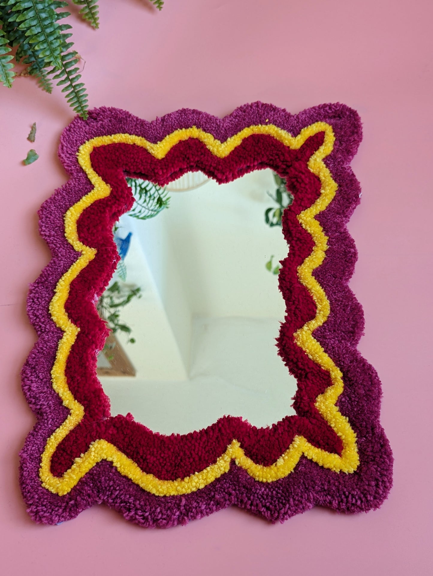 Pink, yellow and red coloured wavy pattern tufted yarn mirror
