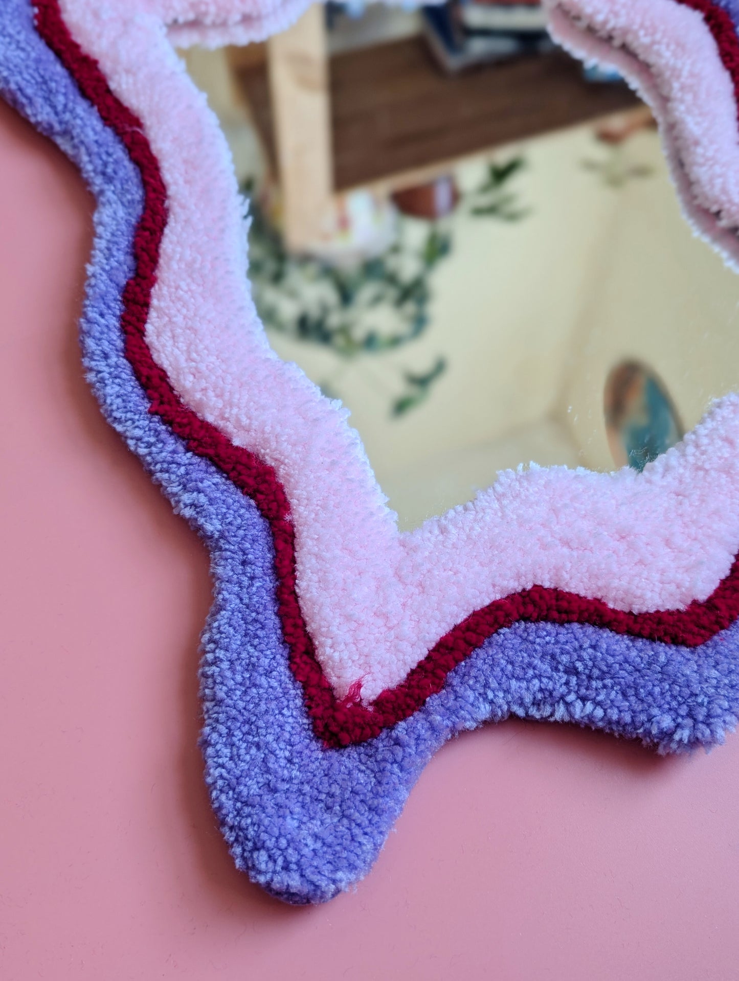 Purple, red and pink coloured wavy pattern tufted yarn mirror