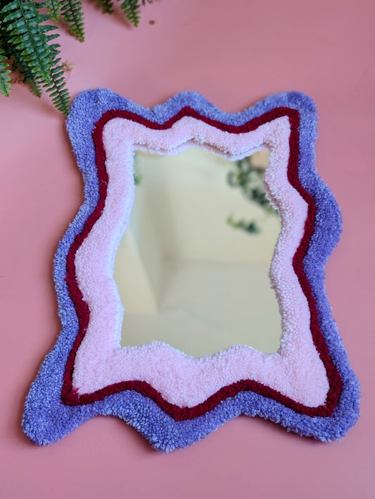 Purple, red and pink coloured wavy pattern tufted yarn mirror