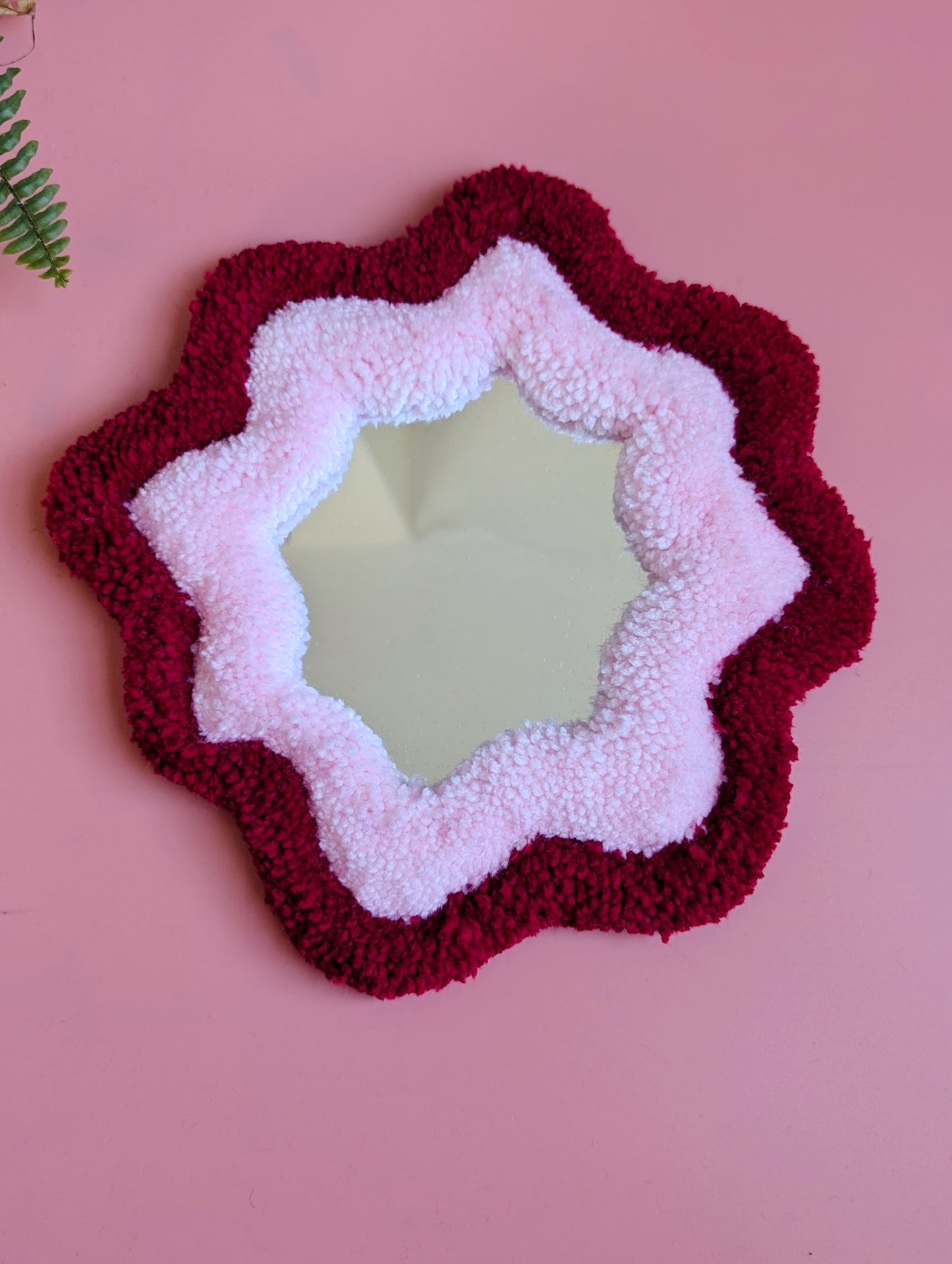 Red and pink coloured wavy pattern tufted yarn mirror