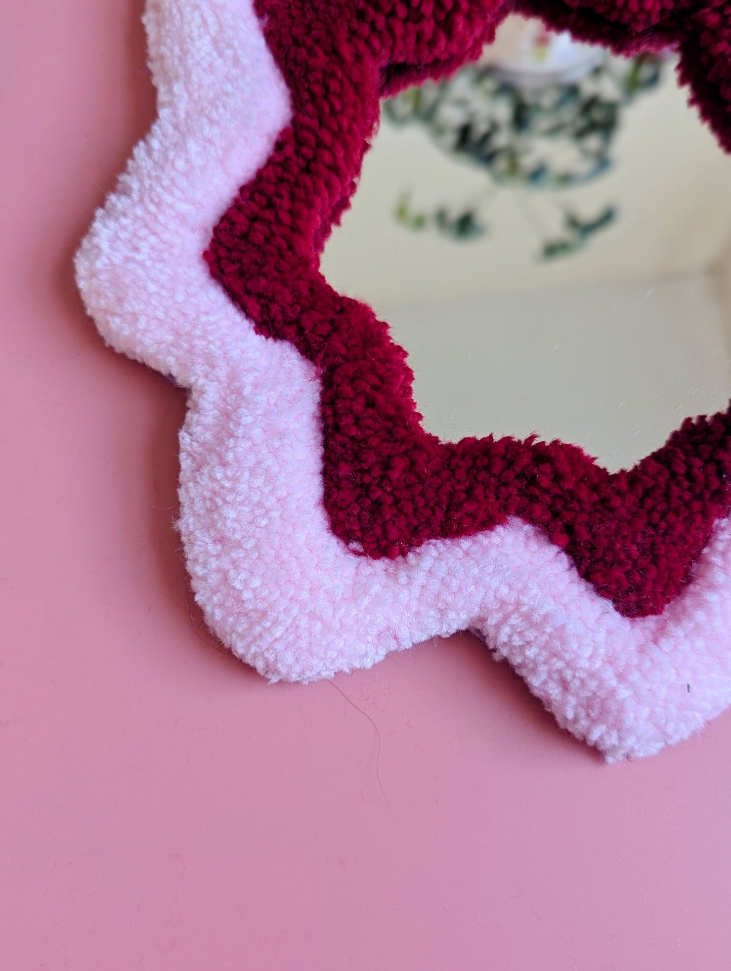 Pink and red coloured wavy pattern tufted yarn mirror