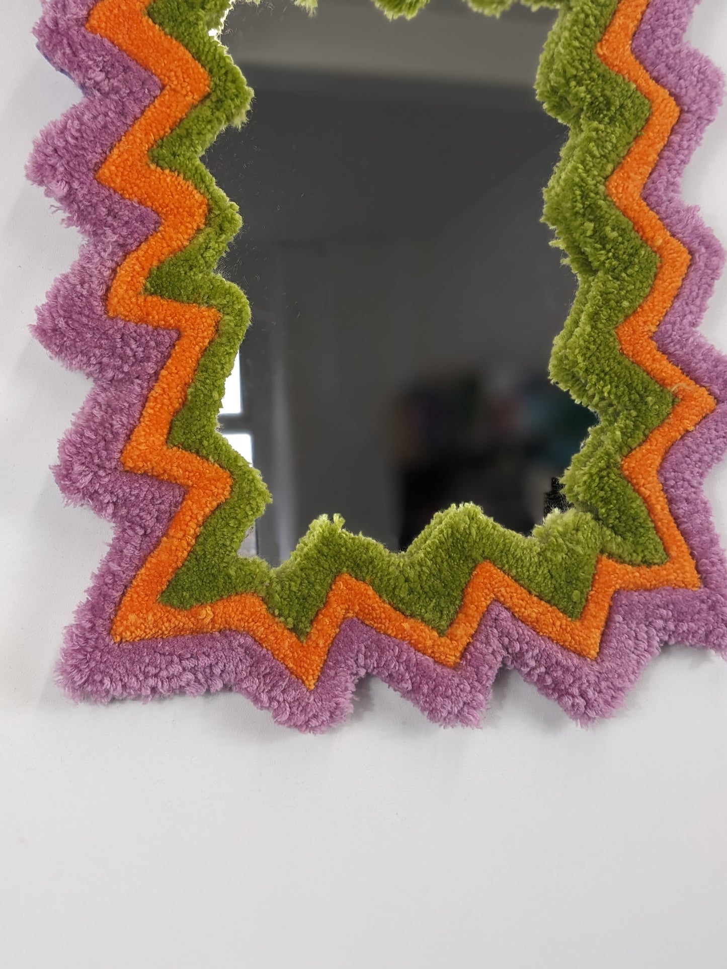 pink orange coloured zigzag pattern tufted yarn mirror