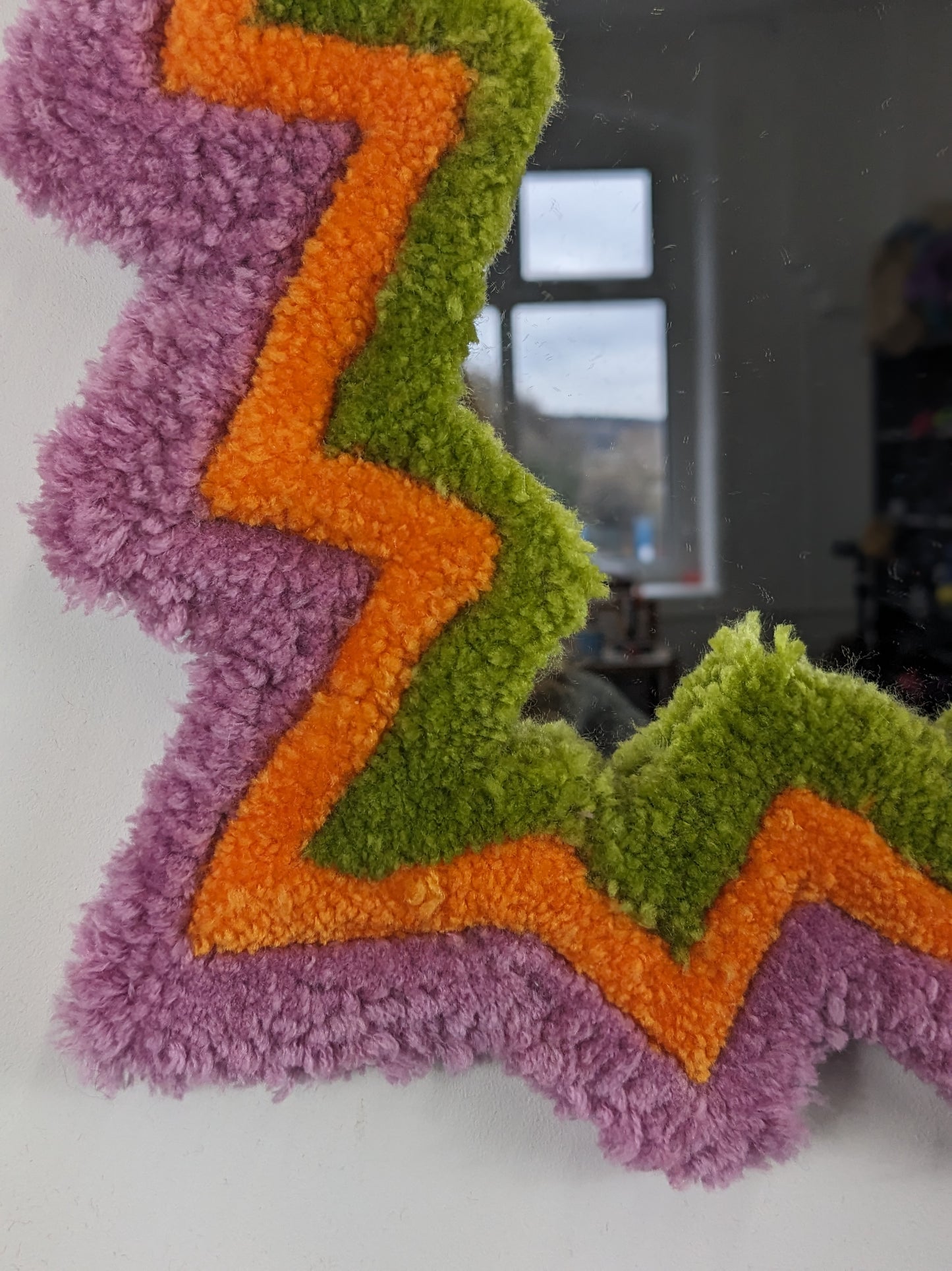 pink orange coloured zigzag pattern tufted yarn mirror