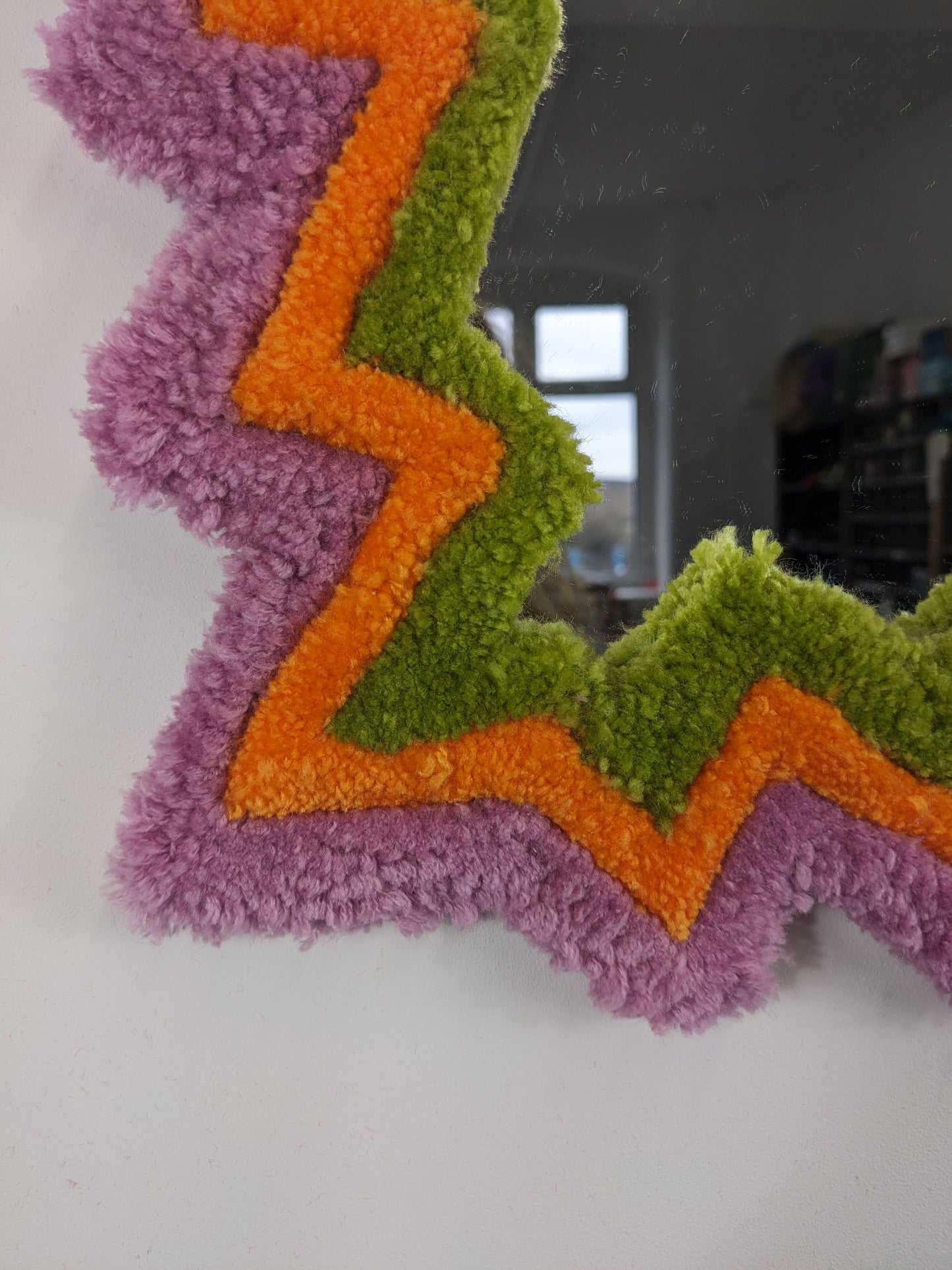 pink orange coloured zigzag pattern tufted yarn mirror