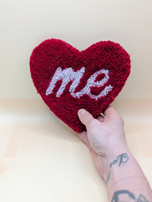 Soft tufted red and purple heart shaped mini rug/coaster with self love slogan