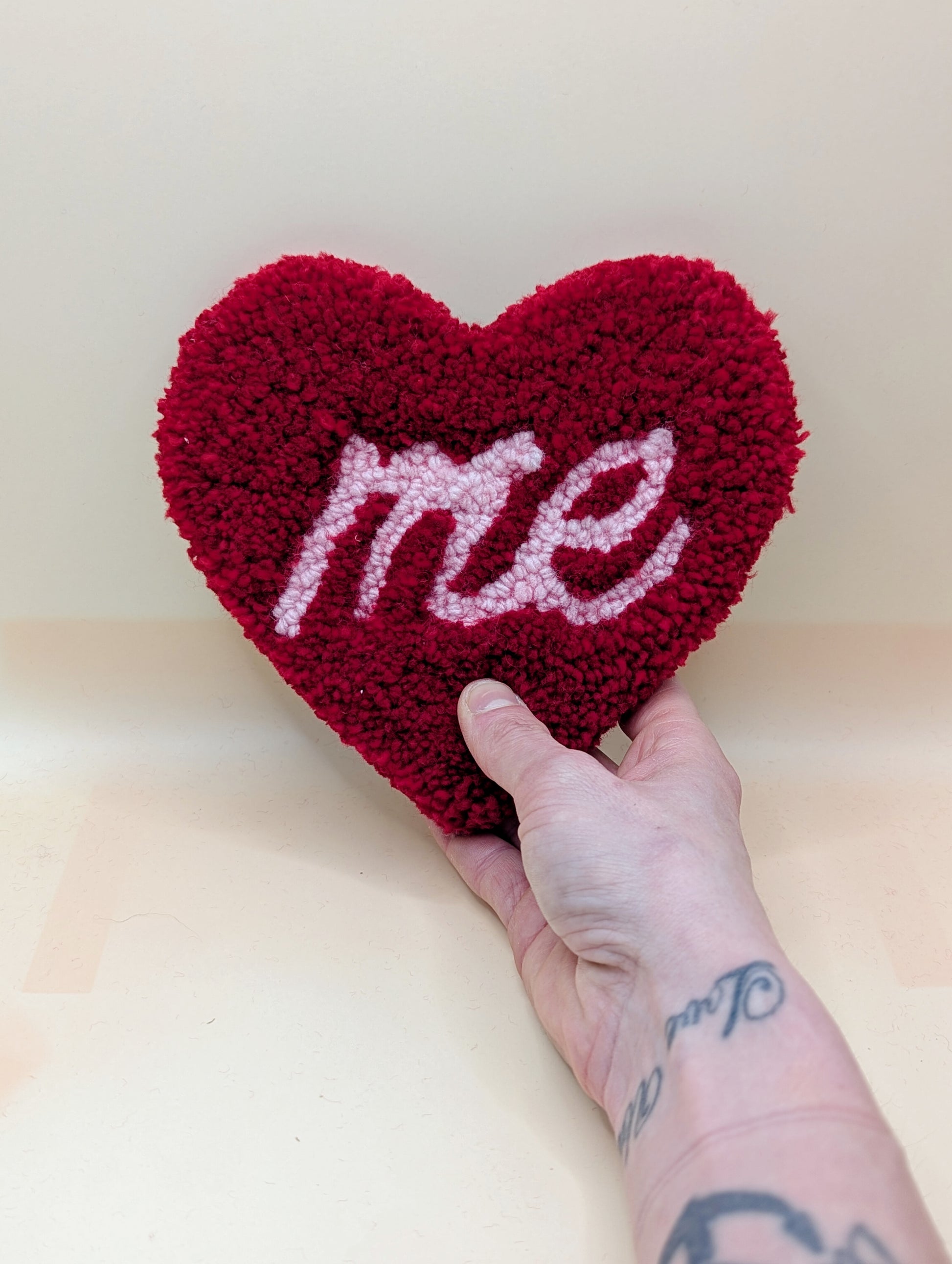 Soft tufted red and pink heart shaped mini rug/coaster with self love slogan