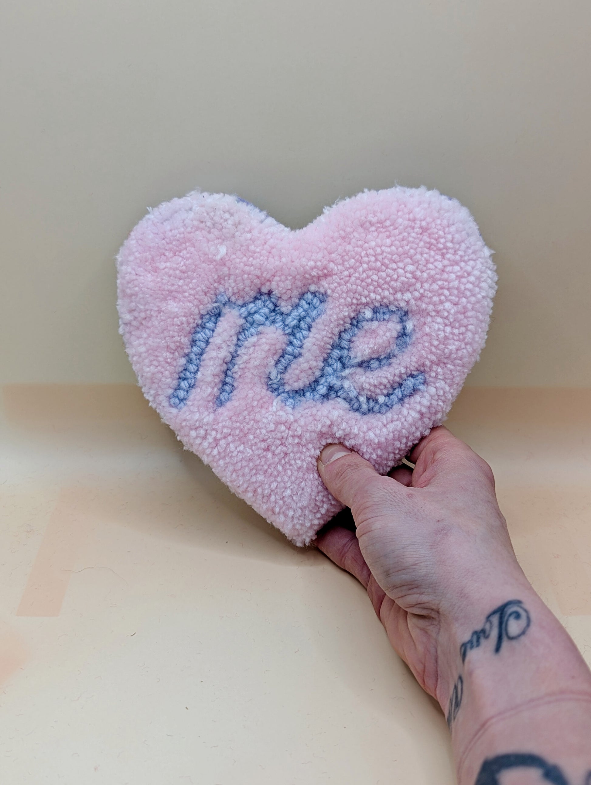 Soft tufted pink and purple heart shaped mini rug/coaster with self love slogan