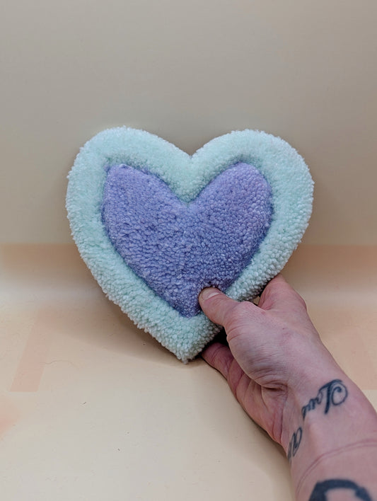 Soft tufted green and purple heart shaped mini rug/coaster 