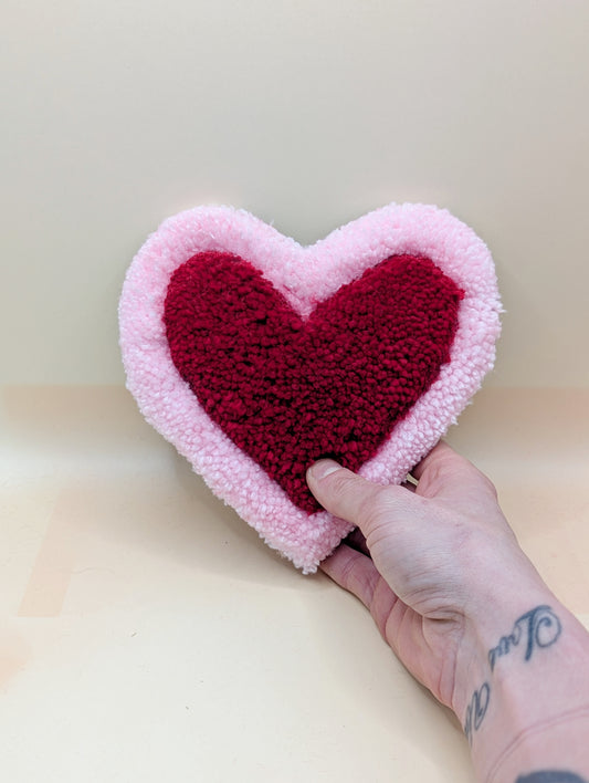 Soft tufted pink and red heart shaped mini rug/coaster 