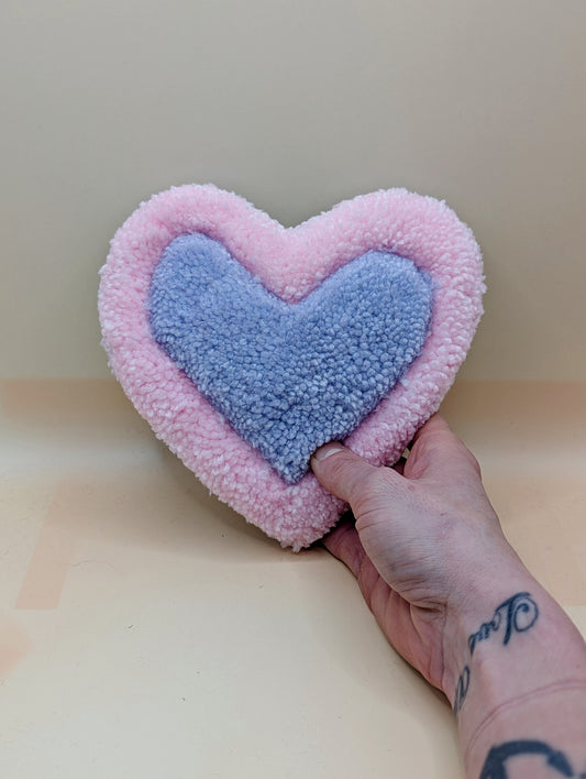 Soft tufted pink and purple heart shaped mini rug/coaster 
