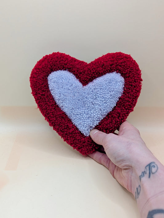 Soft tufted red and purple heart shaped mini rug/coaster 