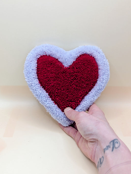 Soft tufted purple and red heart shaped mini rug/coaster 