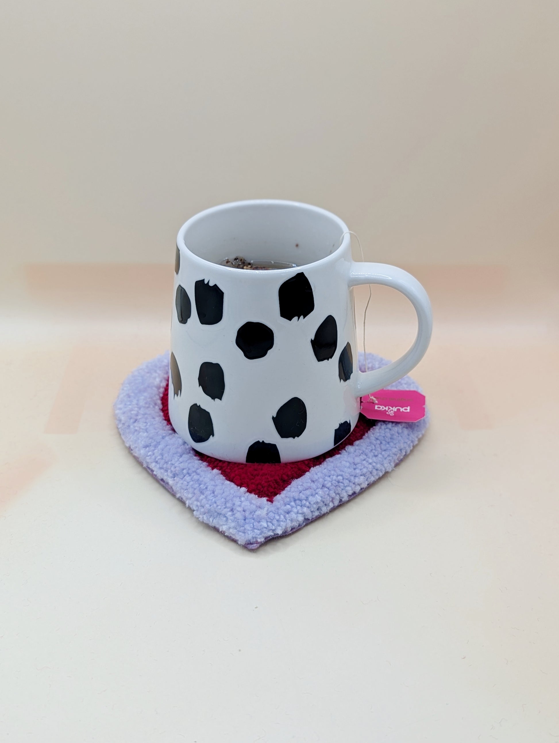 Soft tufted purple and red heart shaped mini rug/coaster 
