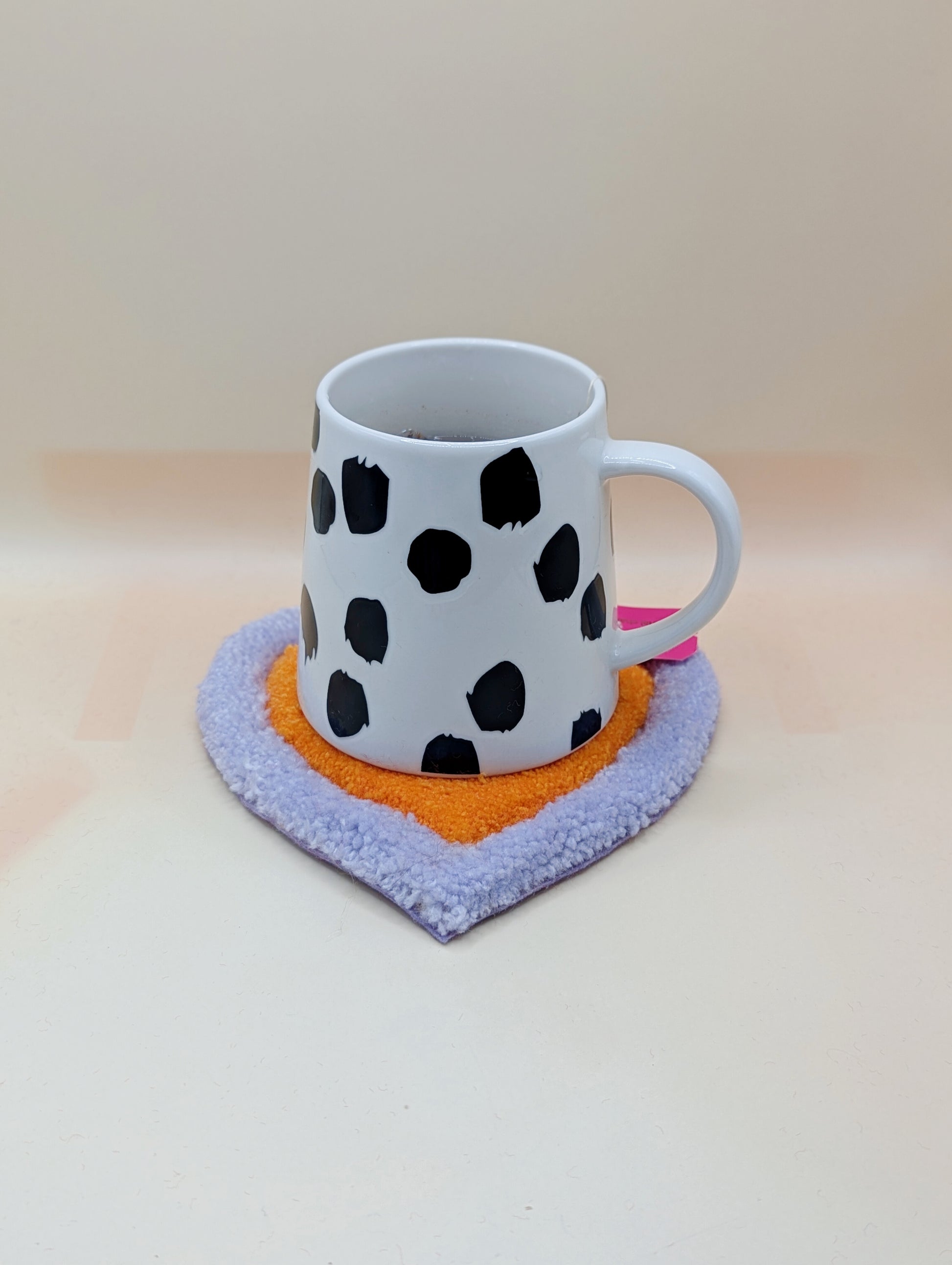 Soft tufted purple and orange heart shaped mini rug/coaster 