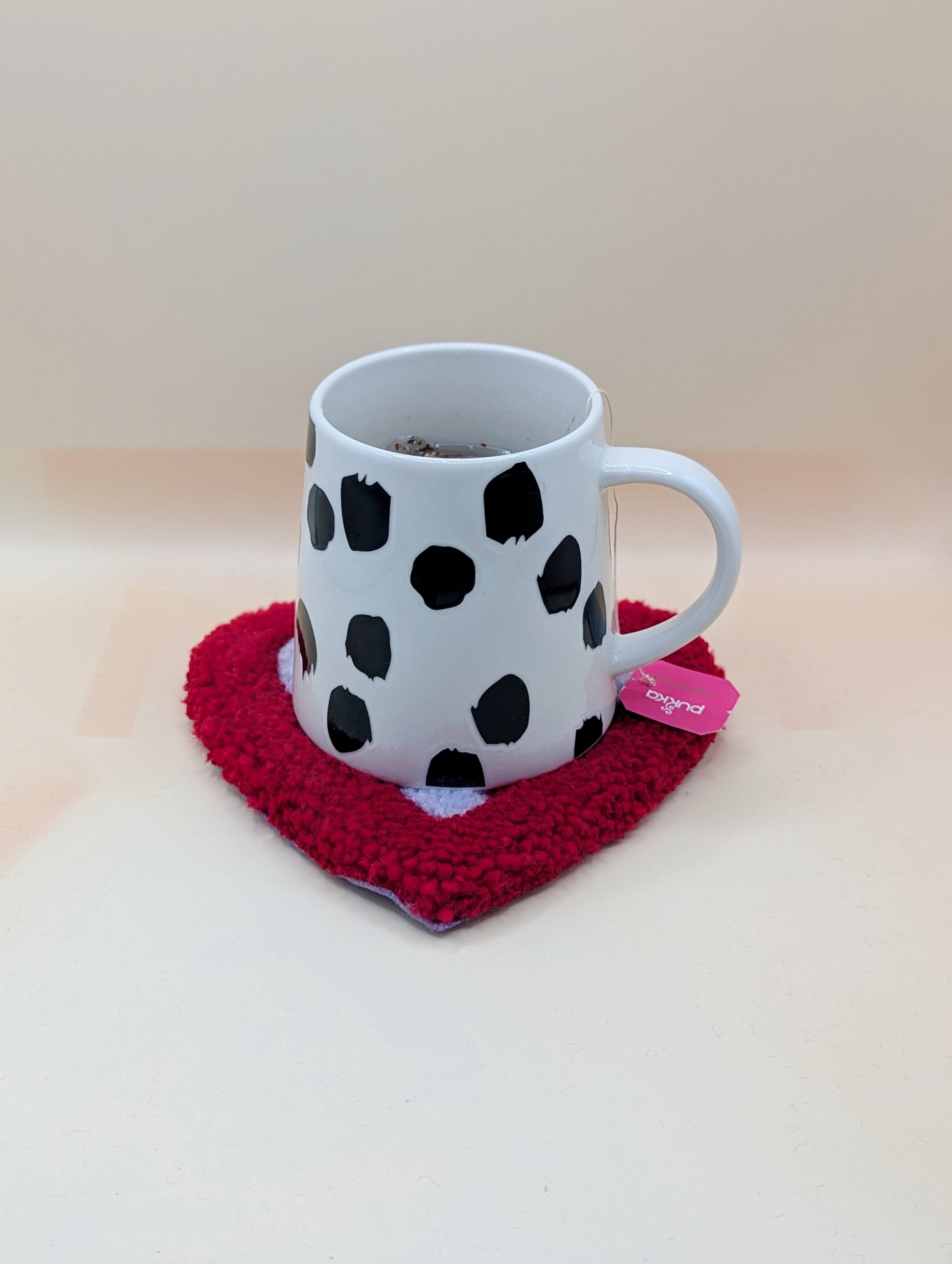 Soft tufted red and purple heart shaped mini rug/coaster 