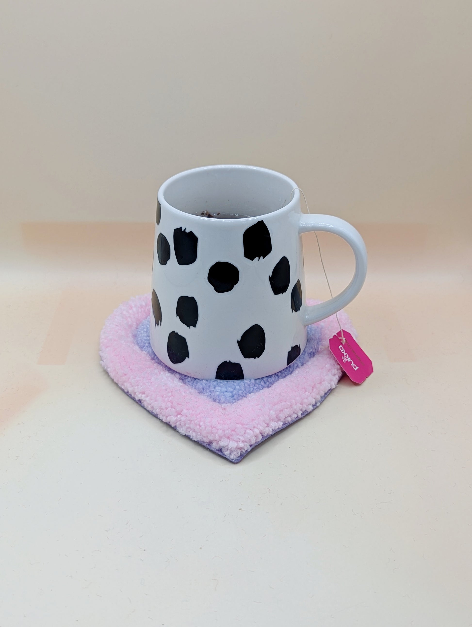 Soft tufted pink and purple heart shaped mini rug/coaster 