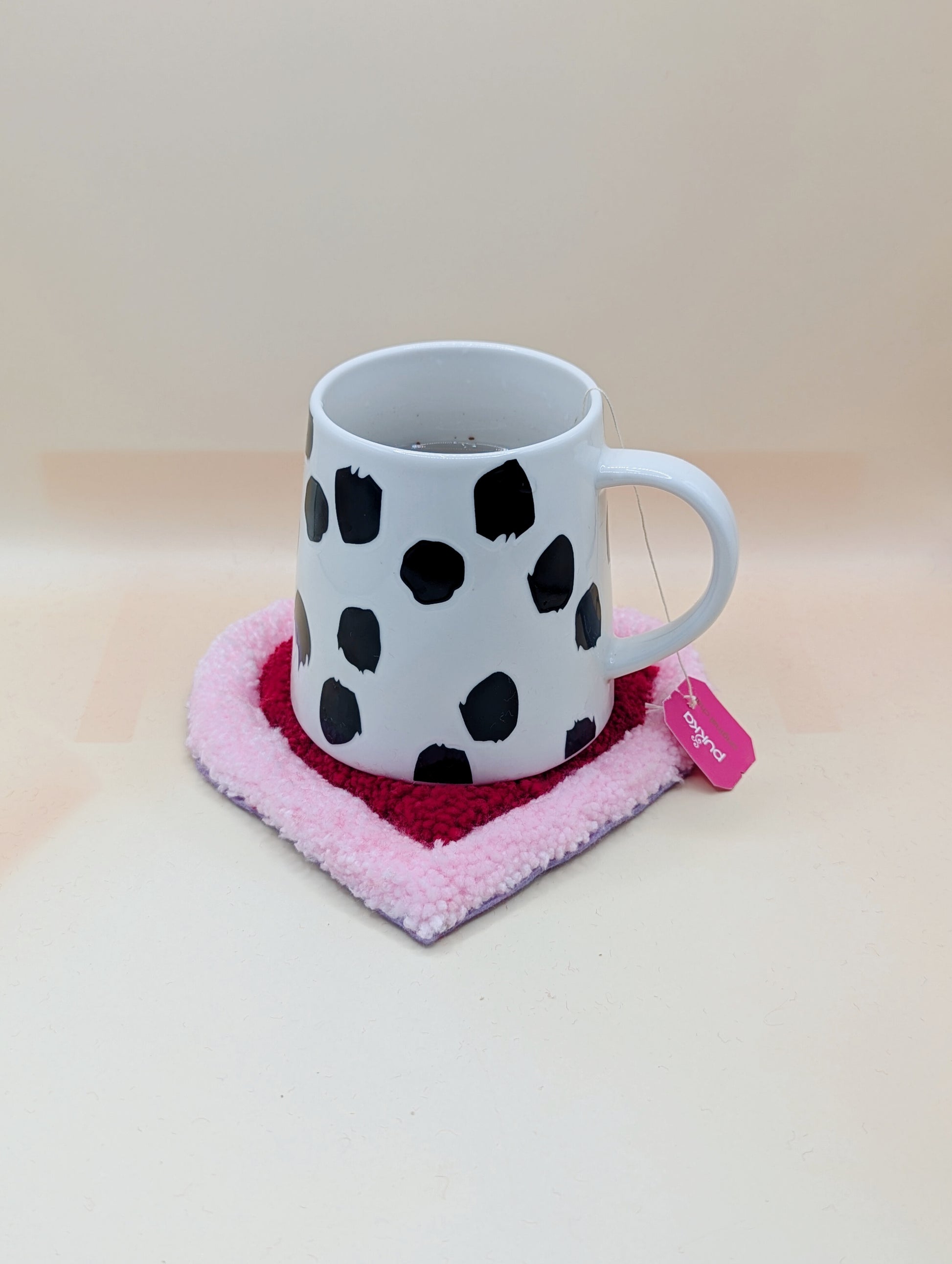 Soft tufted pink and red heart shaped mini rug/coaster 