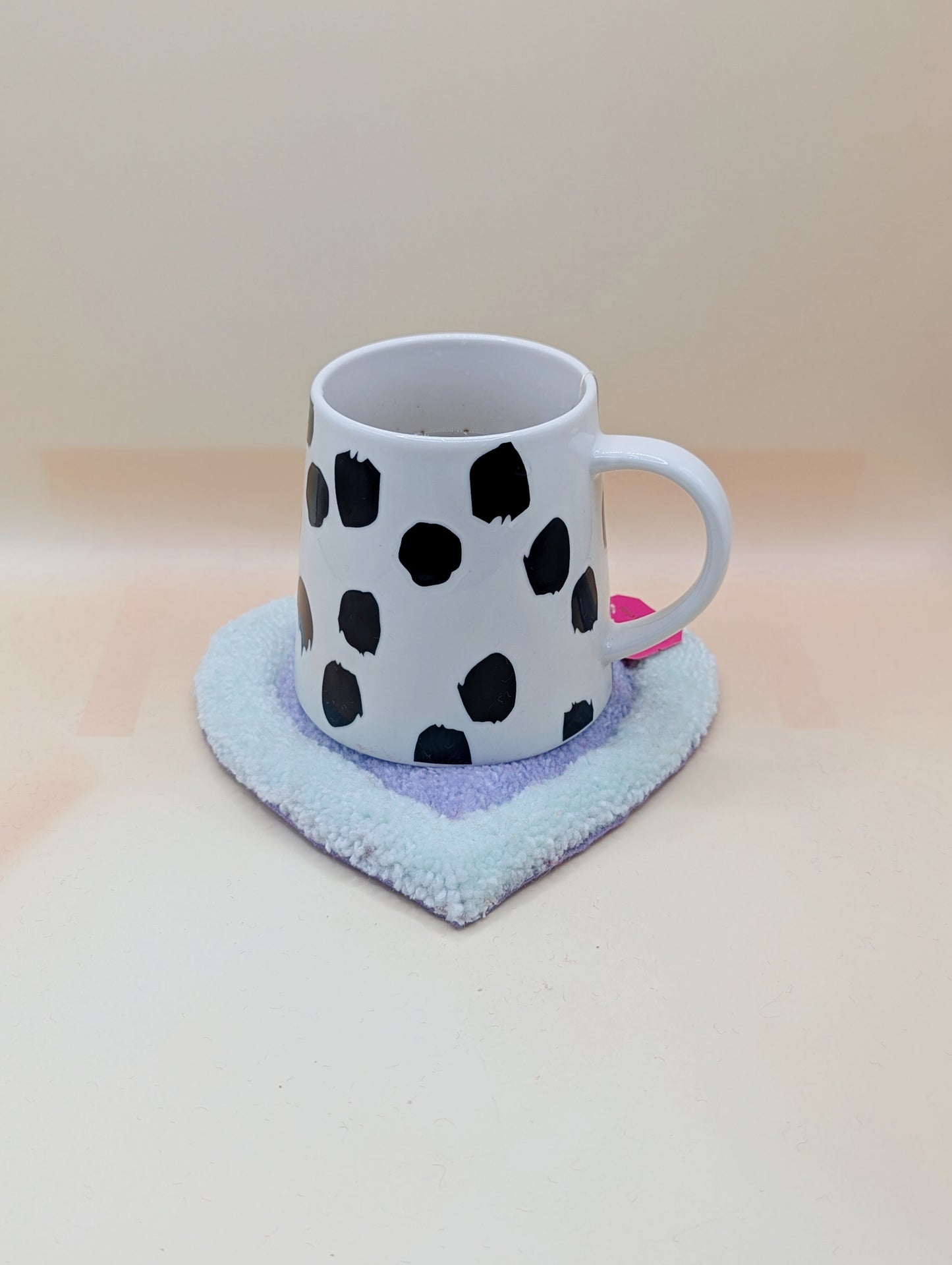 Soft tufted green and purple heart shaped mini rug/coaster 