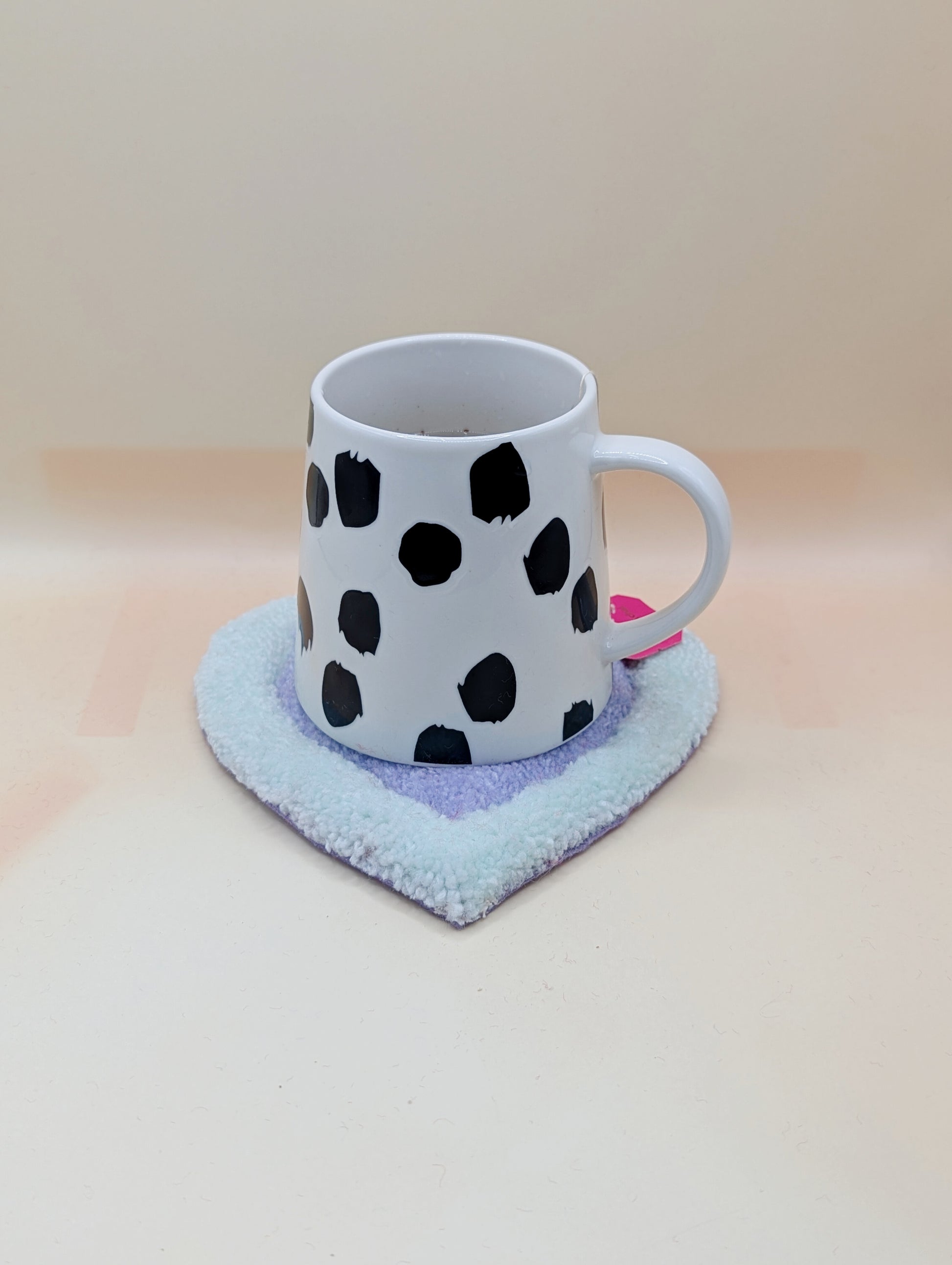 Soft tufted green and purple heart shaped mini rug/coaster 