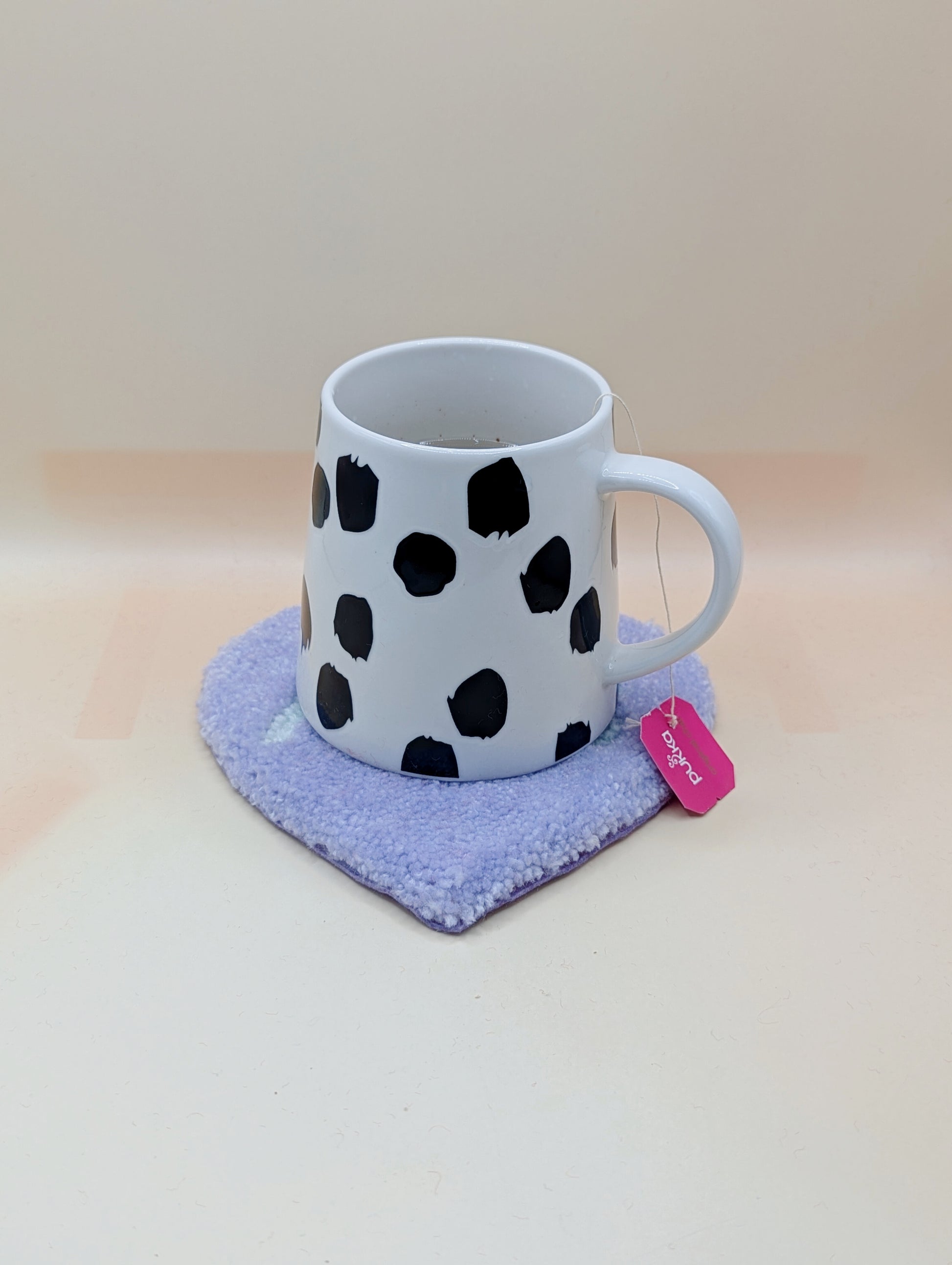 Soft tufted purple and green heart shaped mini rug/coaster with self love slogan