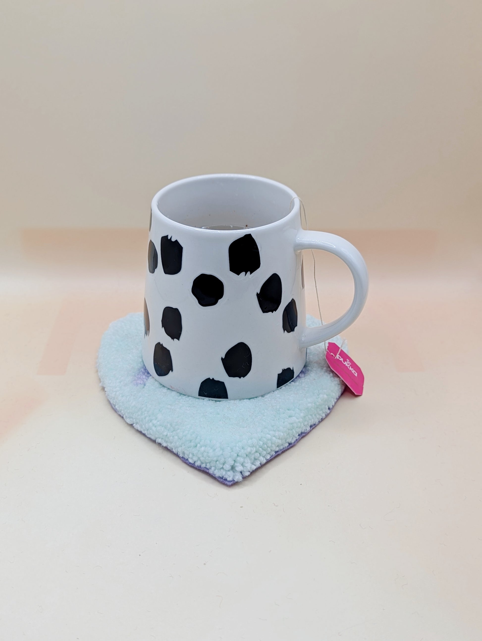 Soft tufted green and purple heart shaped mini rug/coaster with self love slogan