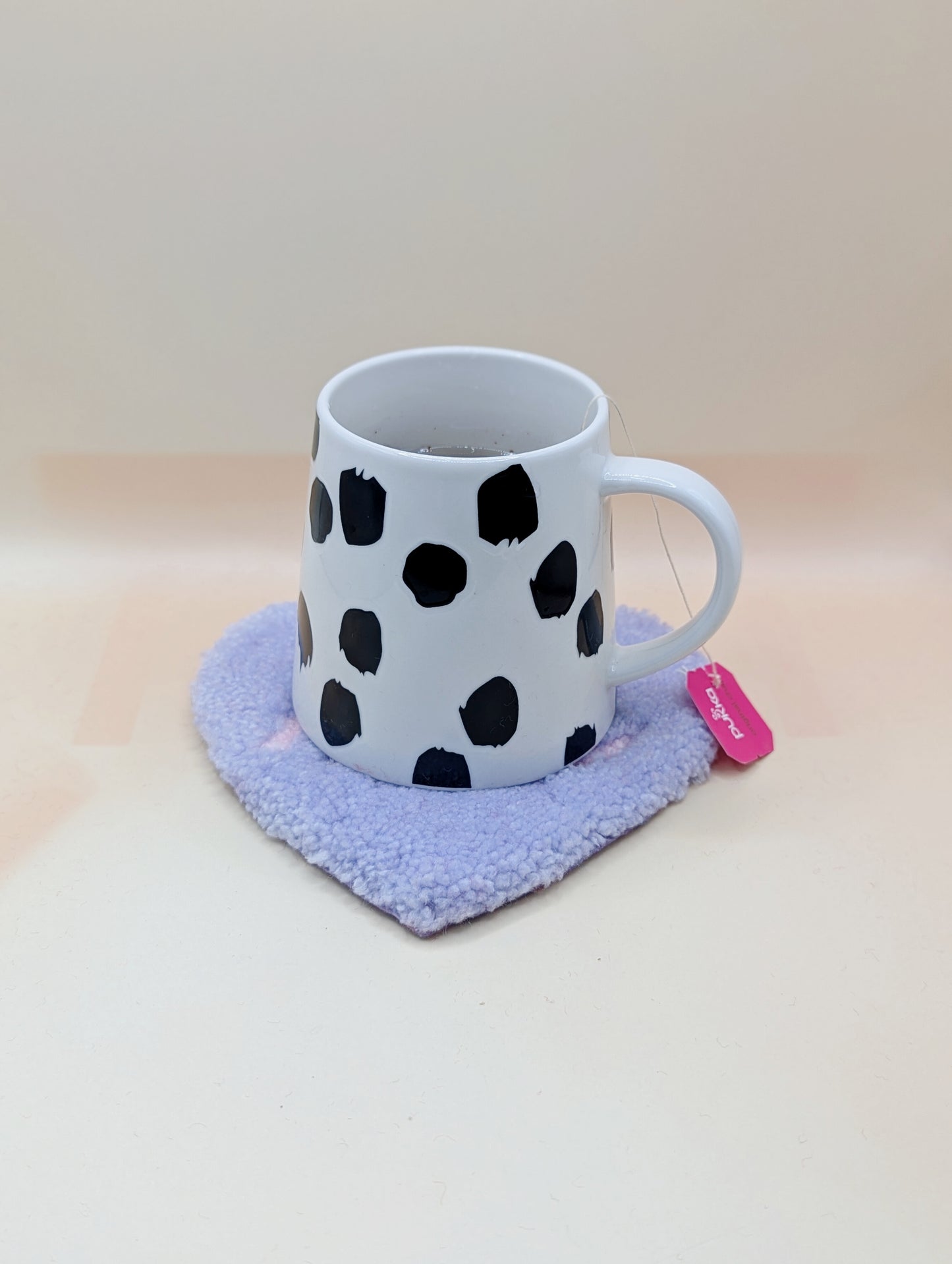 Soft tufted purple and pink heart shaped mini rug/coaster with self love slogan