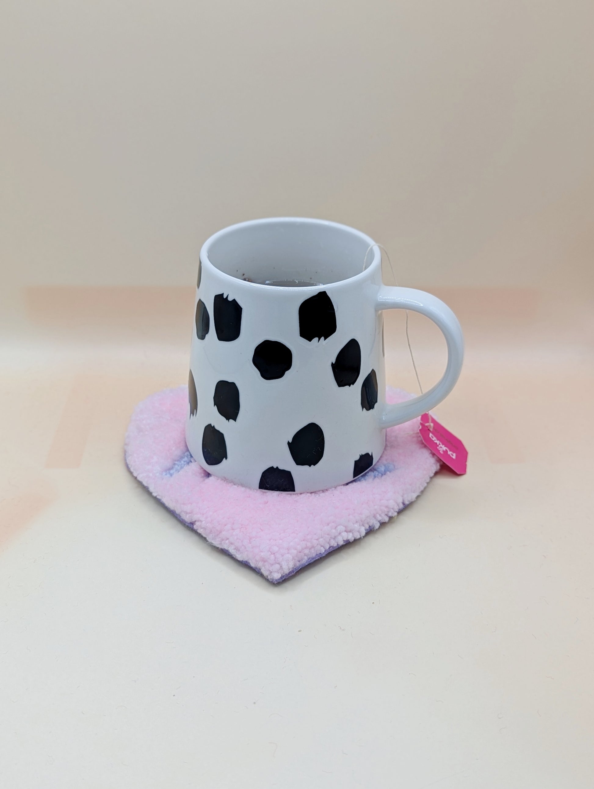 Soft tufted pink and purple heart shaped mini rug/coaster with self love slogan