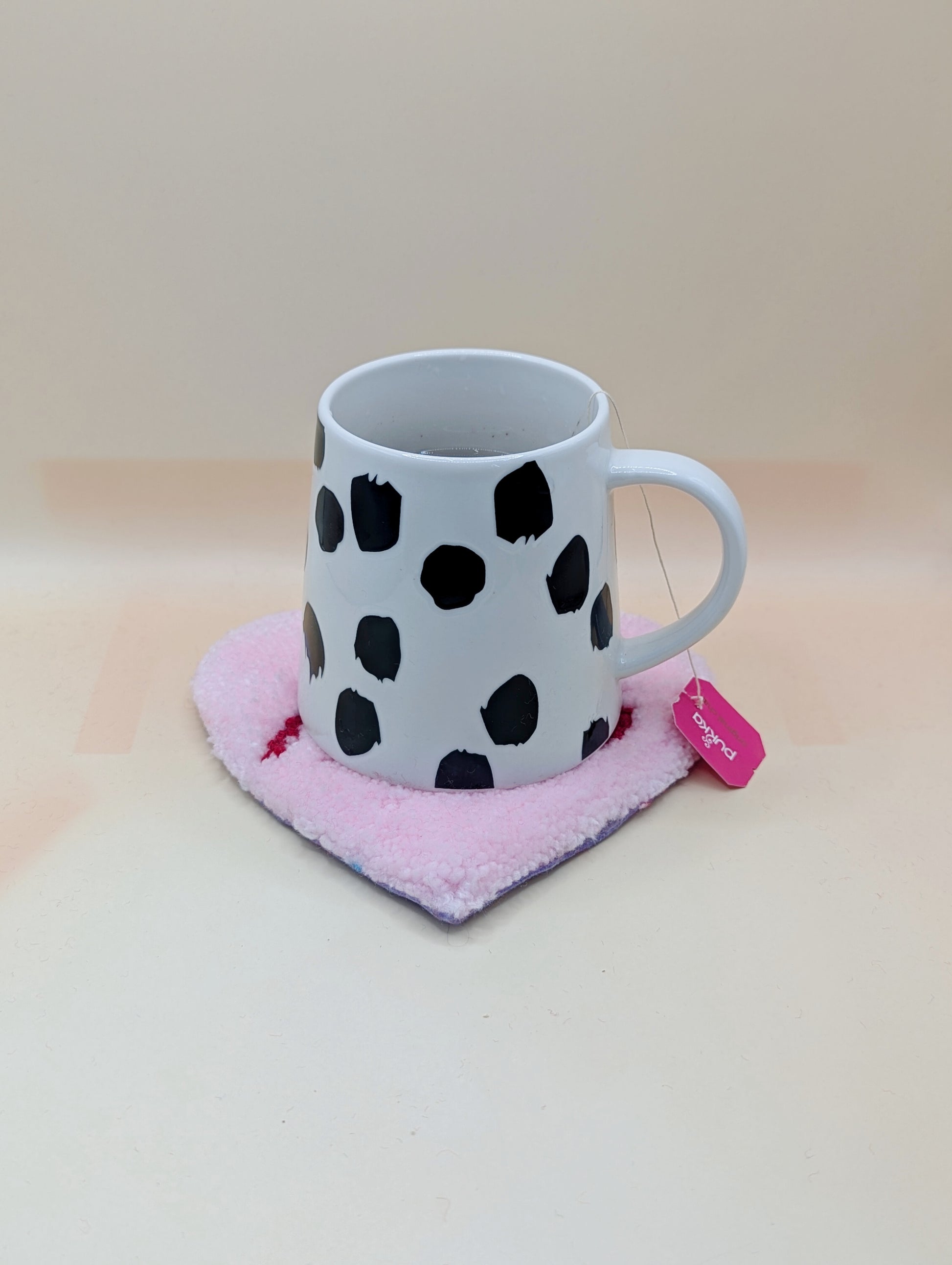 Soft tufted pink and red heart shaped mini rug/coaster with self love slogan