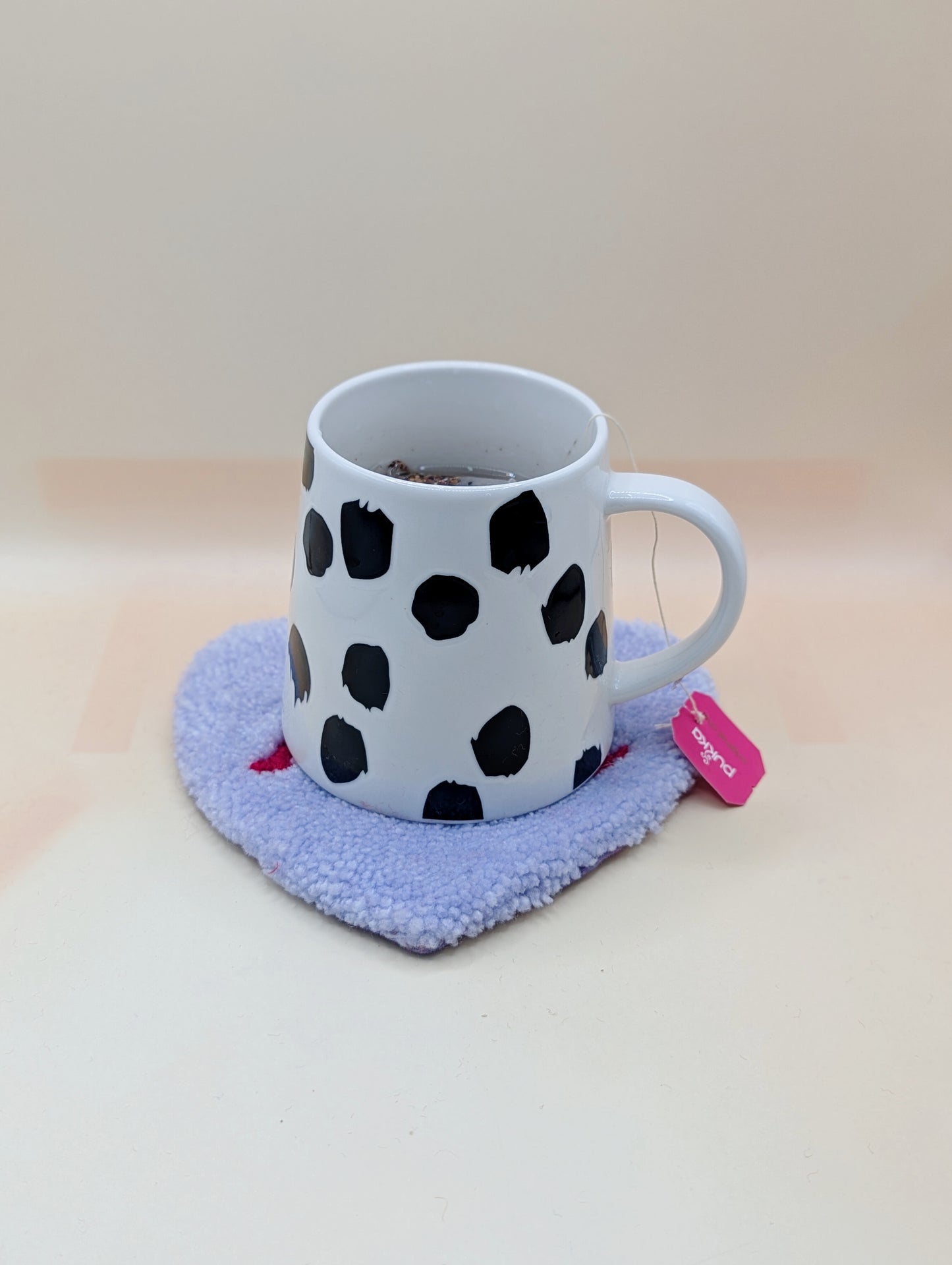 Soft tufted purple and red heart shaped mini rug/coaster with self love slogan