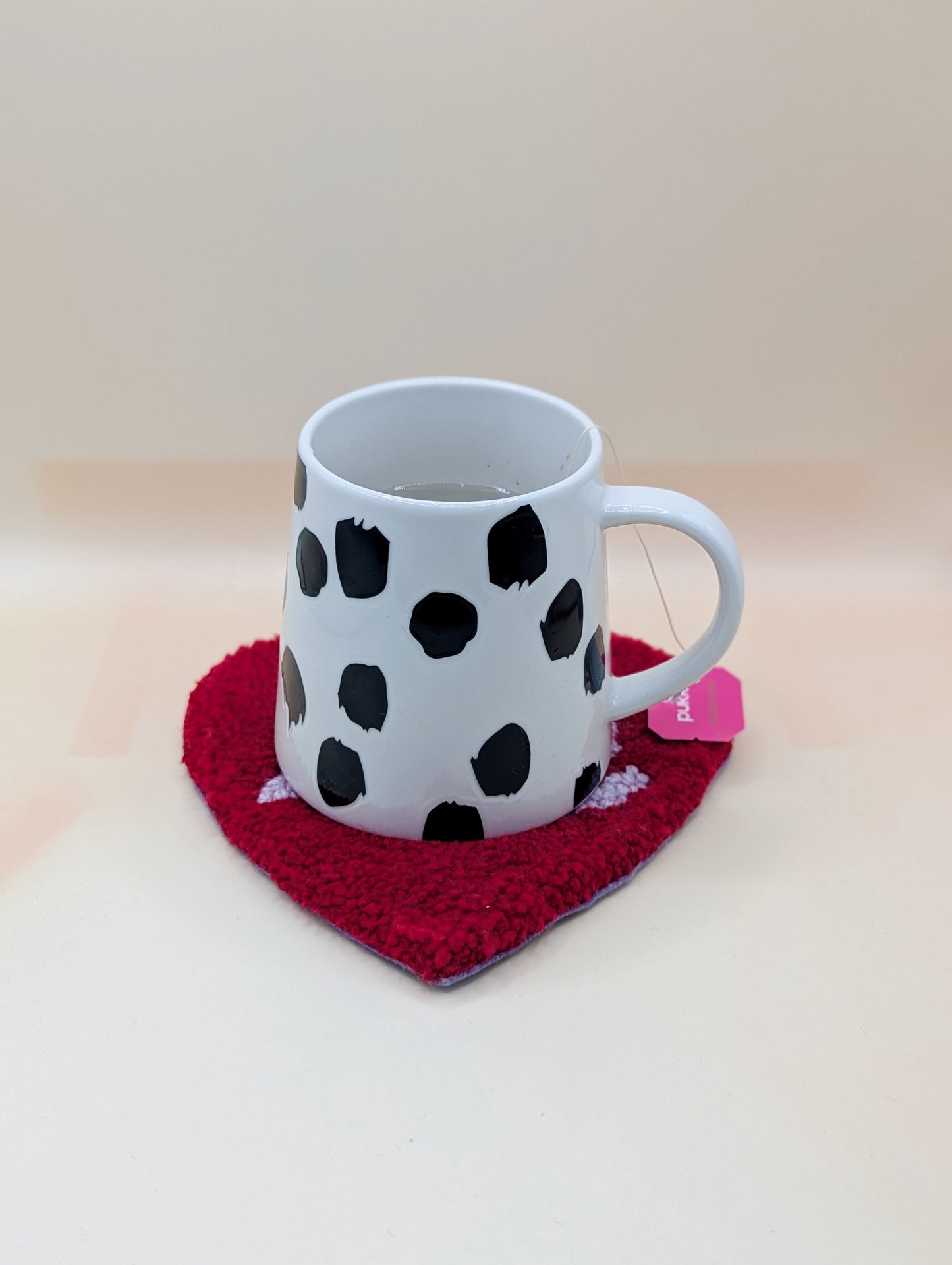 Soft tufted red and purple heart shaped mini rug/coaster with self love slogan