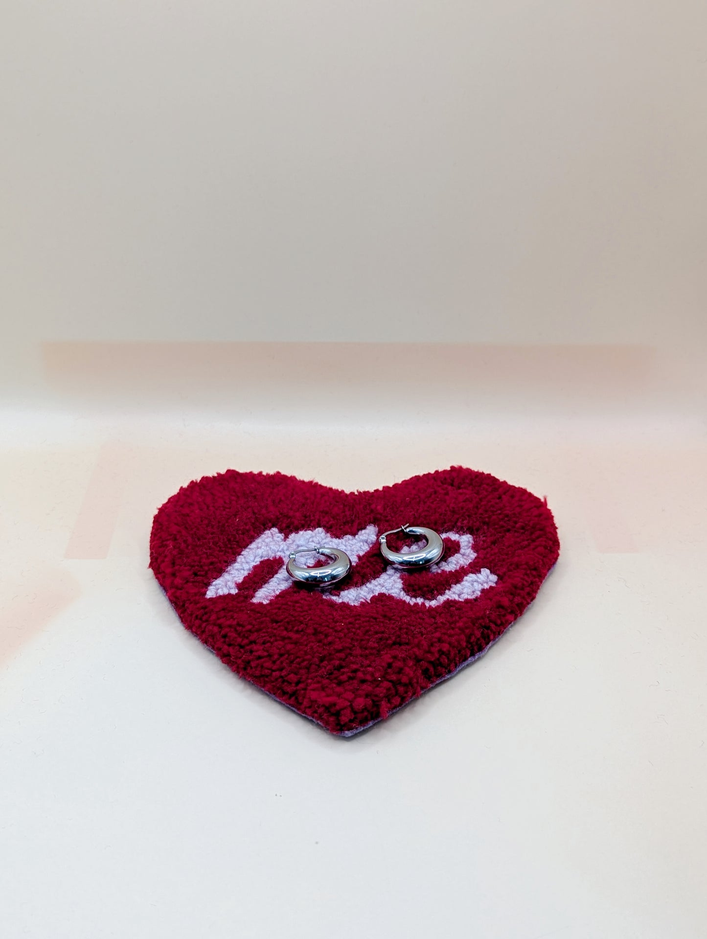 Soft tufted red and purple heart shaped mini rug/coaster with self love slogan