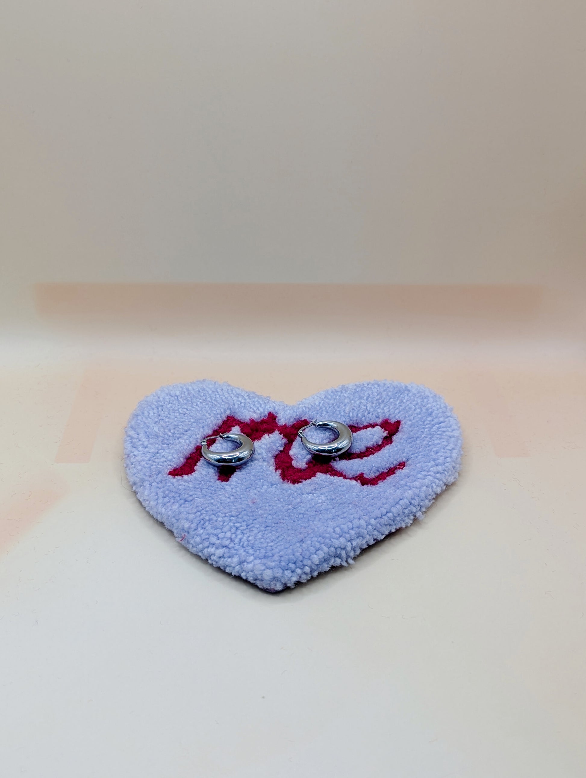 Soft tufted purple and red heart shaped mini rug/coaster with self love slogan