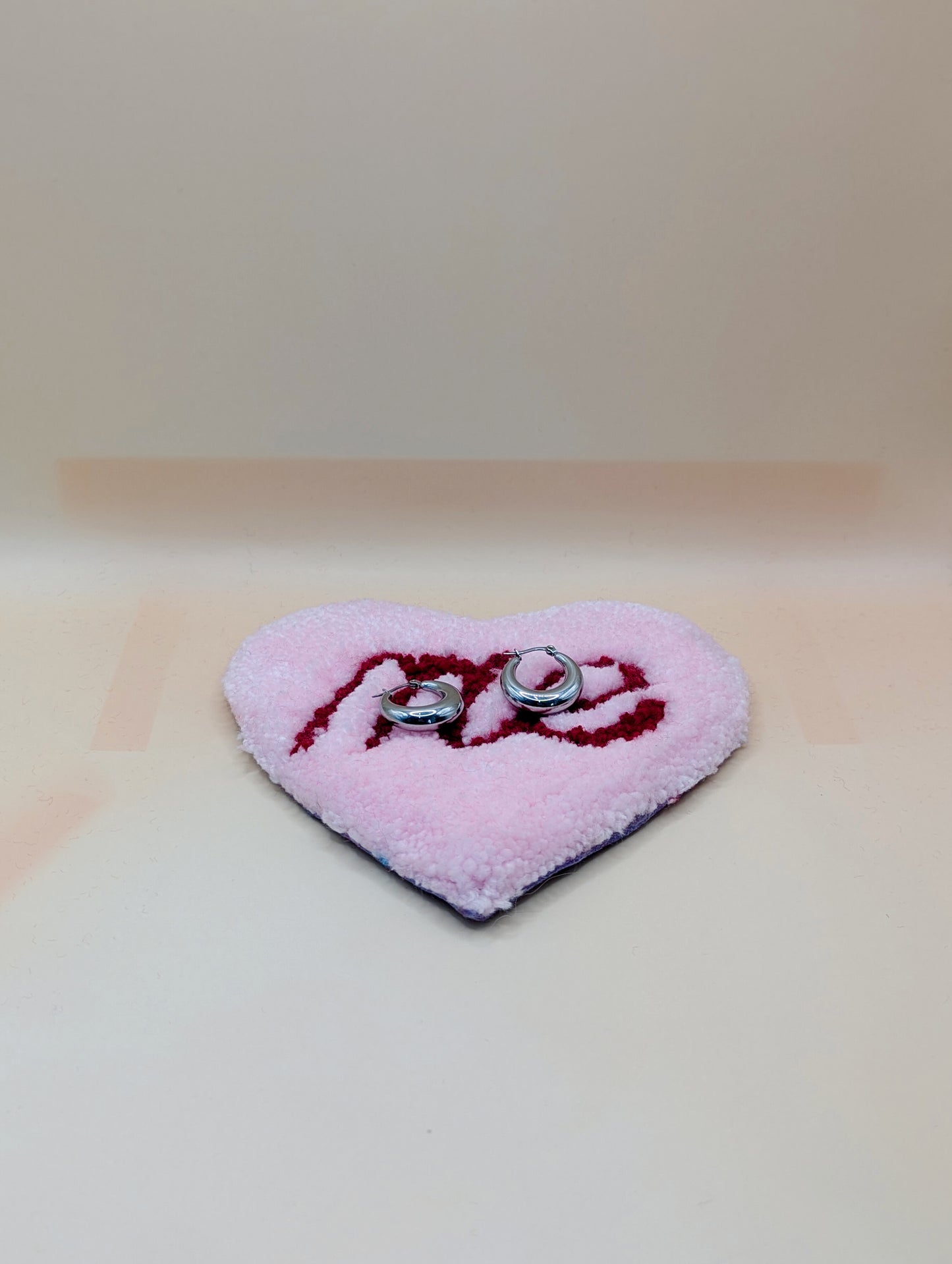 Soft tufted pink and red heart shaped mini rug/coaster with self love slogan