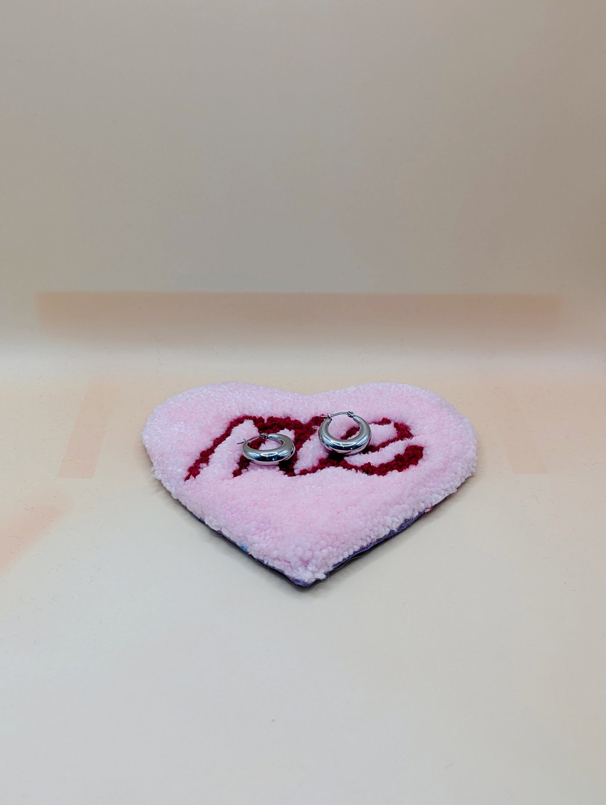 Soft tufted pink and red heart shaped mini rug/coaster with self love slogan