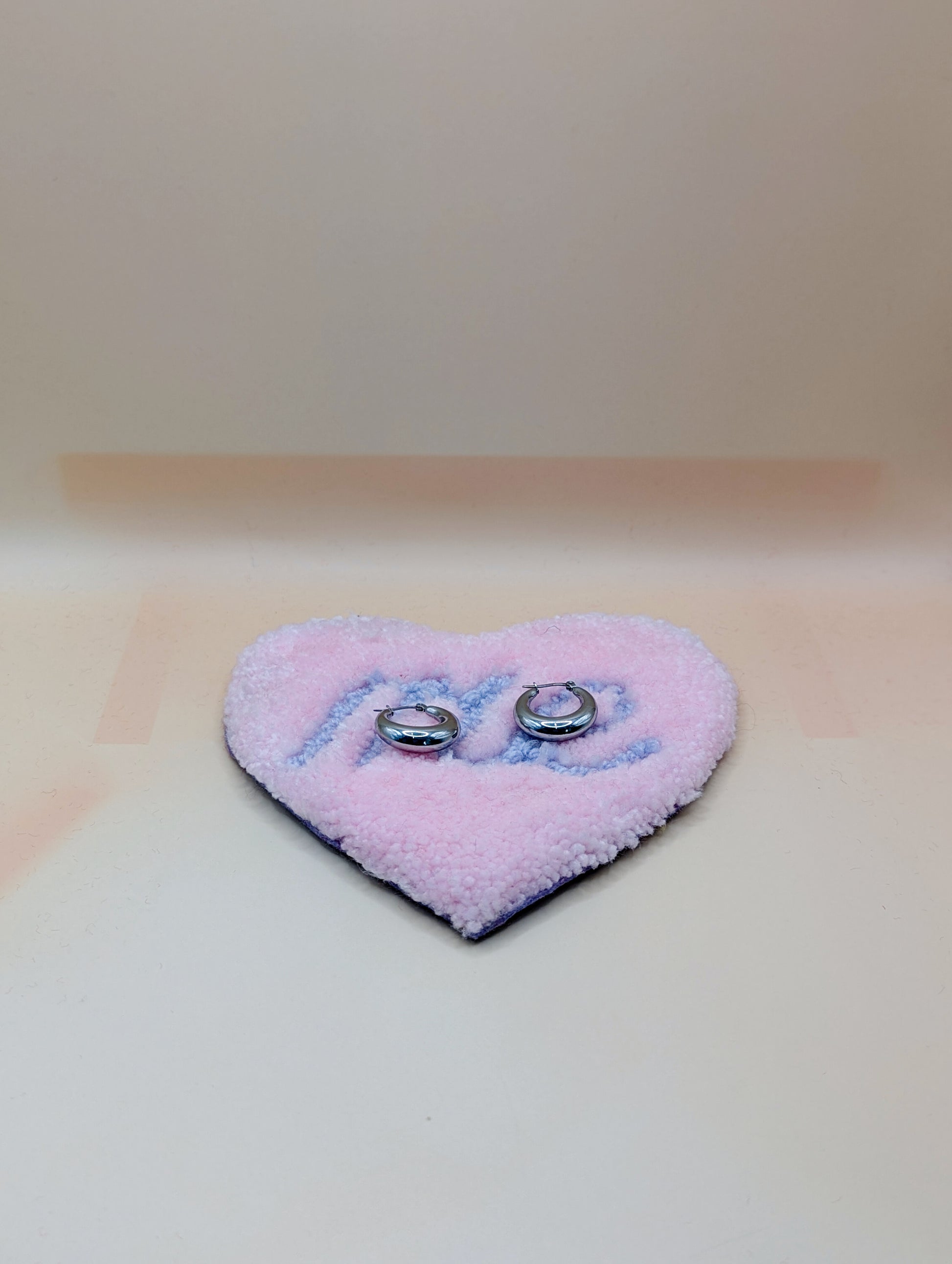 Soft tufted pink and purple heart shaped mini rug/coaster with self love slogan