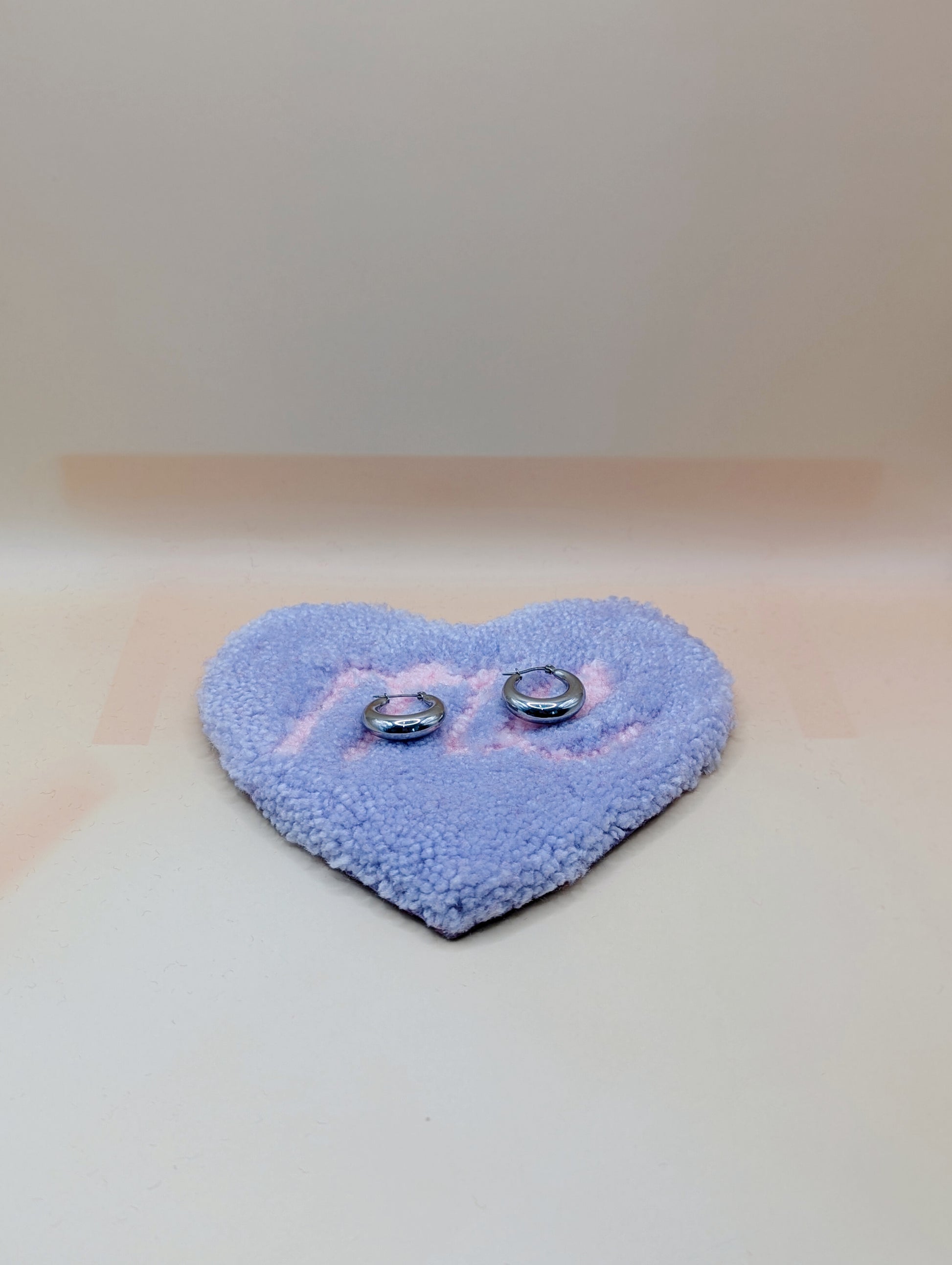 Soft tufted purple and pink heart shaped mini rug/coaster with self love slogan