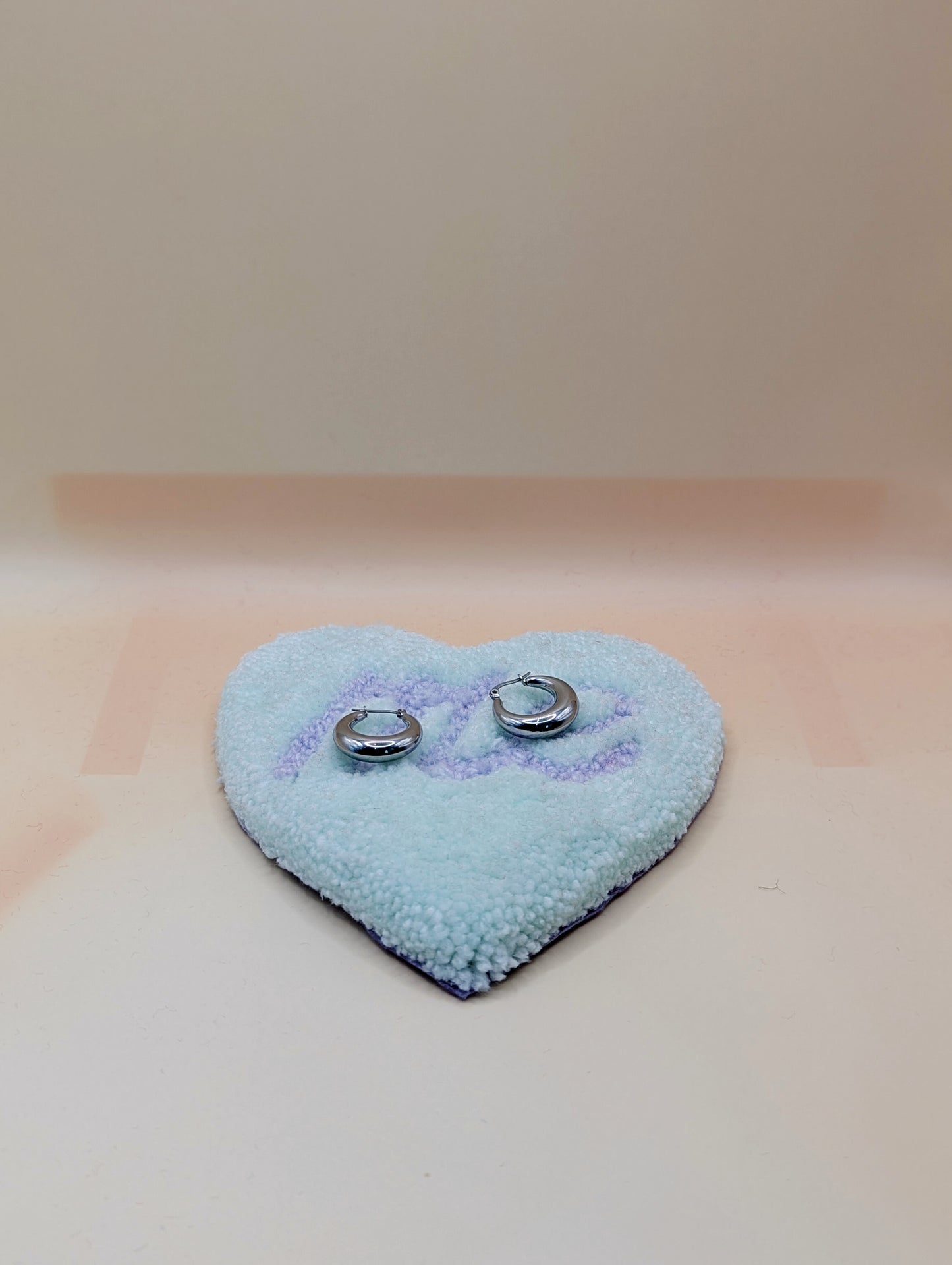 Soft tufted green and purple heart shaped mini rug/coaster with self love slogan