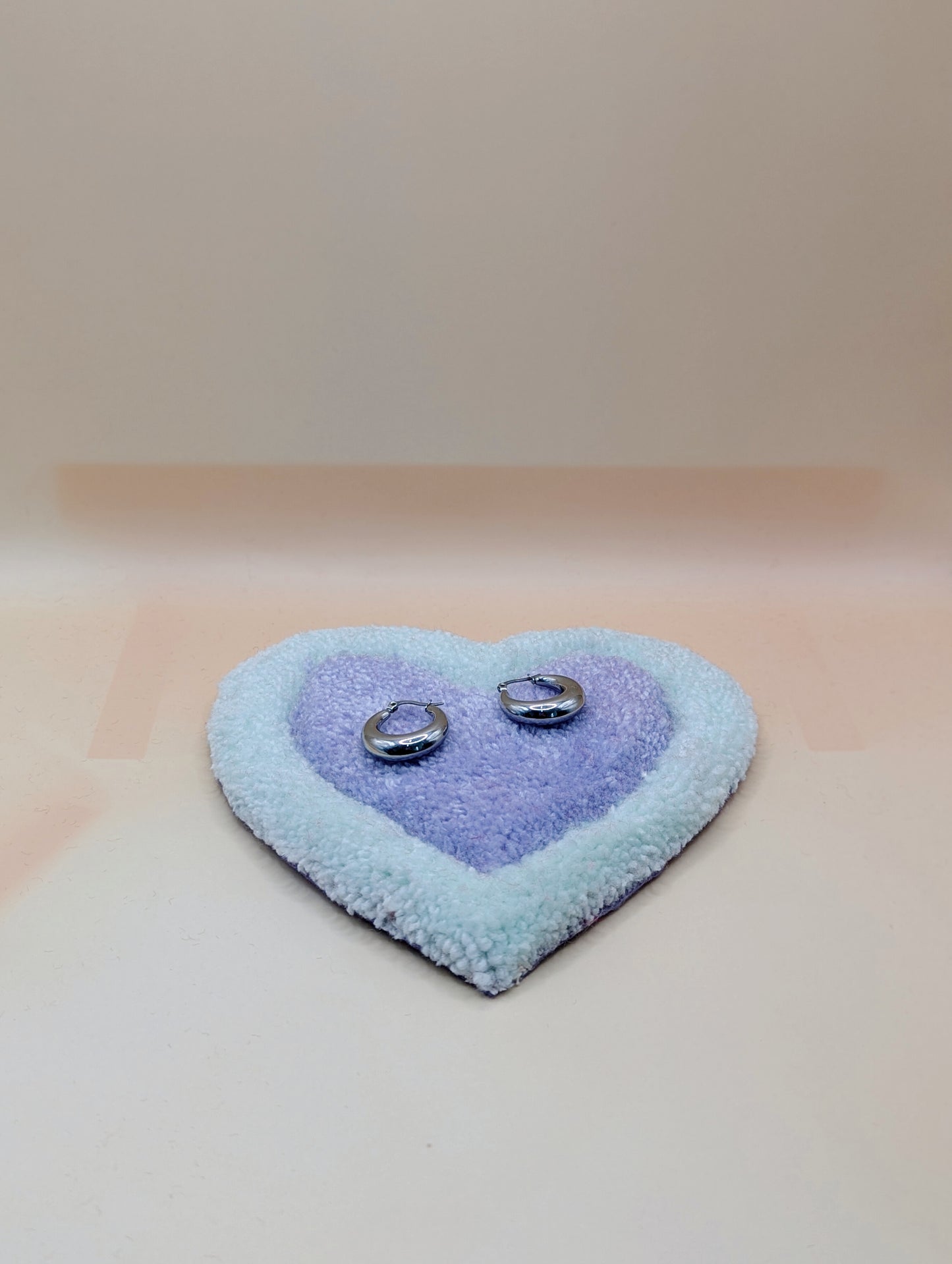 Soft tufted green and purple heart shaped mini rug/coaster 