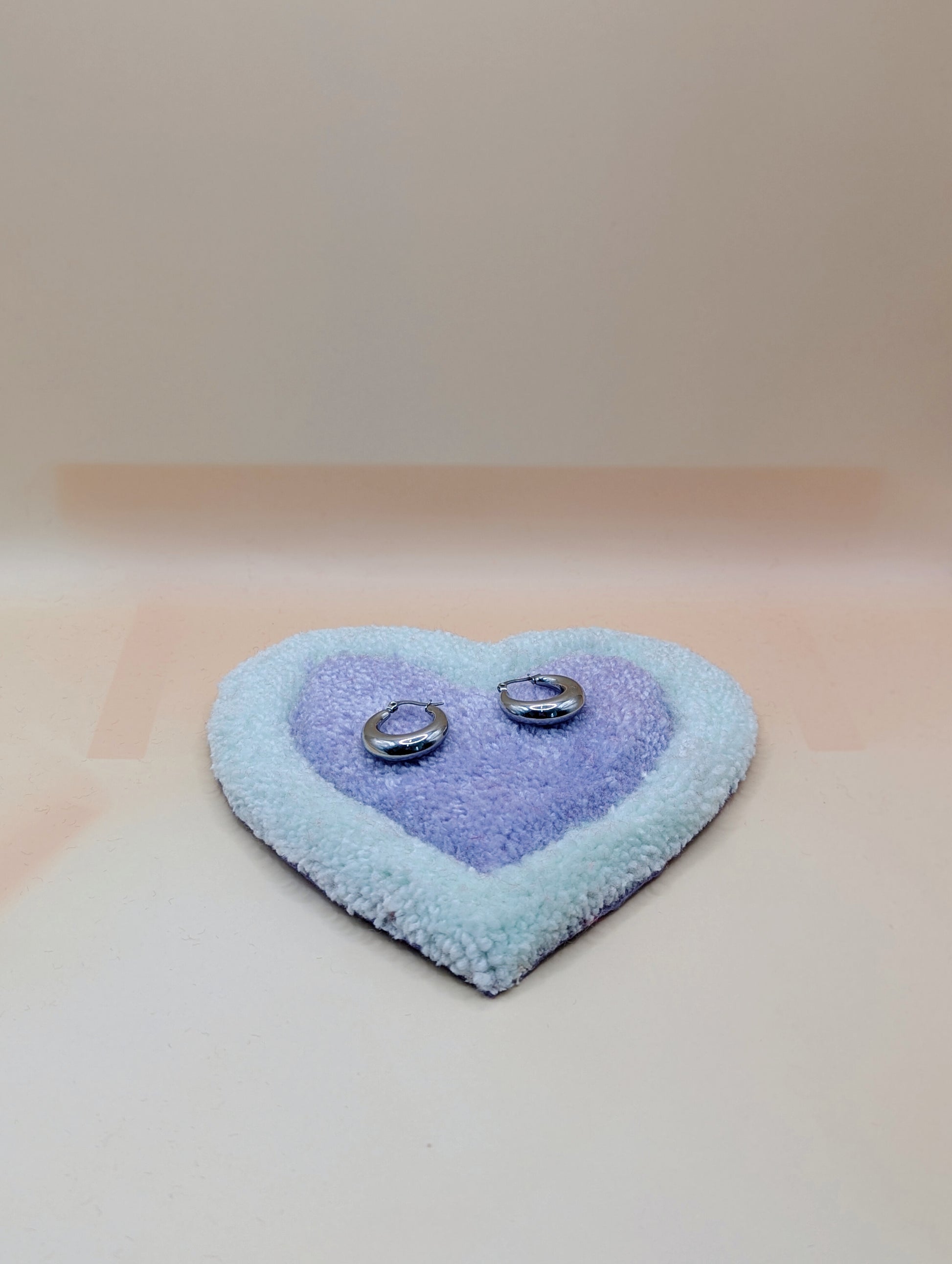Soft tufted green and purple heart shaped mini rug/coaster 
