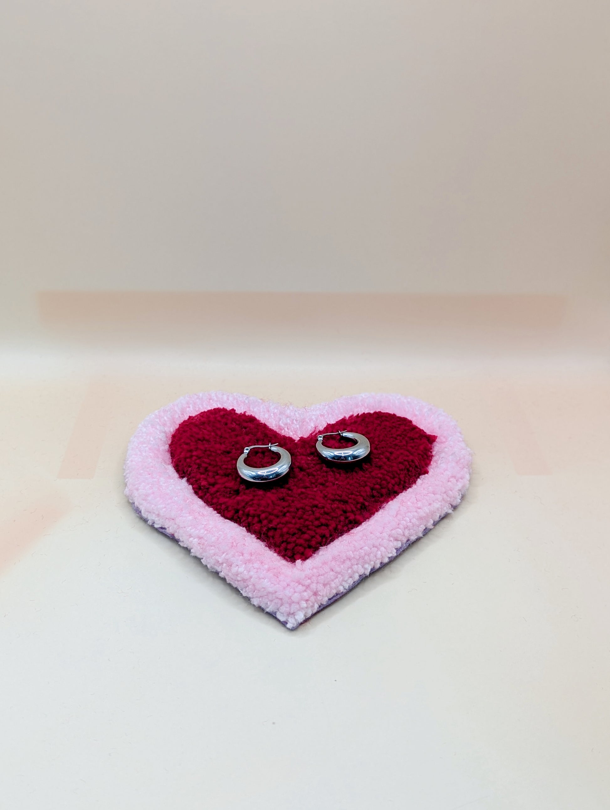 Soft tufted pink and red heart shaped mini rug/coaster 