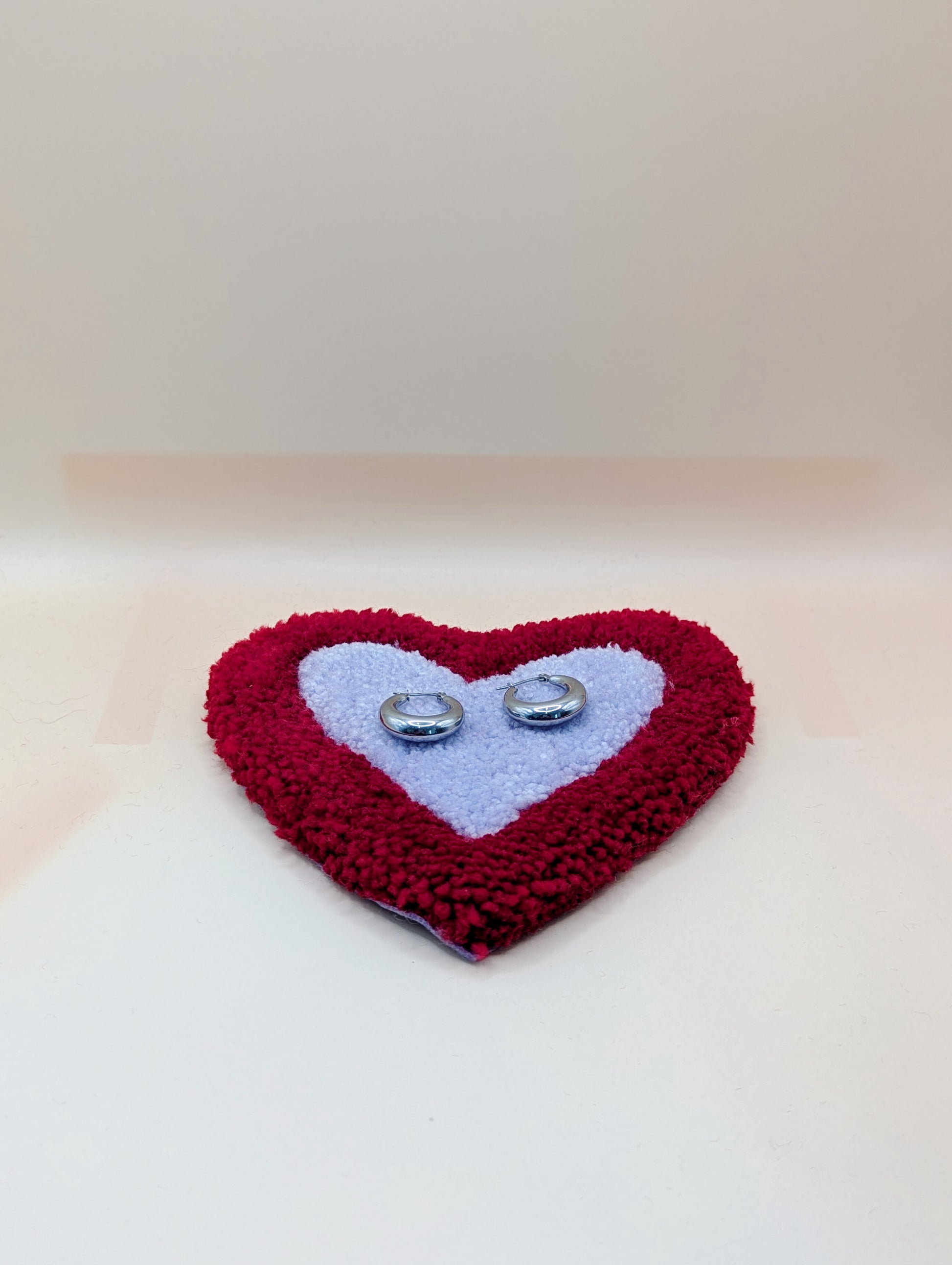 Soft tufted red and purple heart shaped mini rug/coaster 