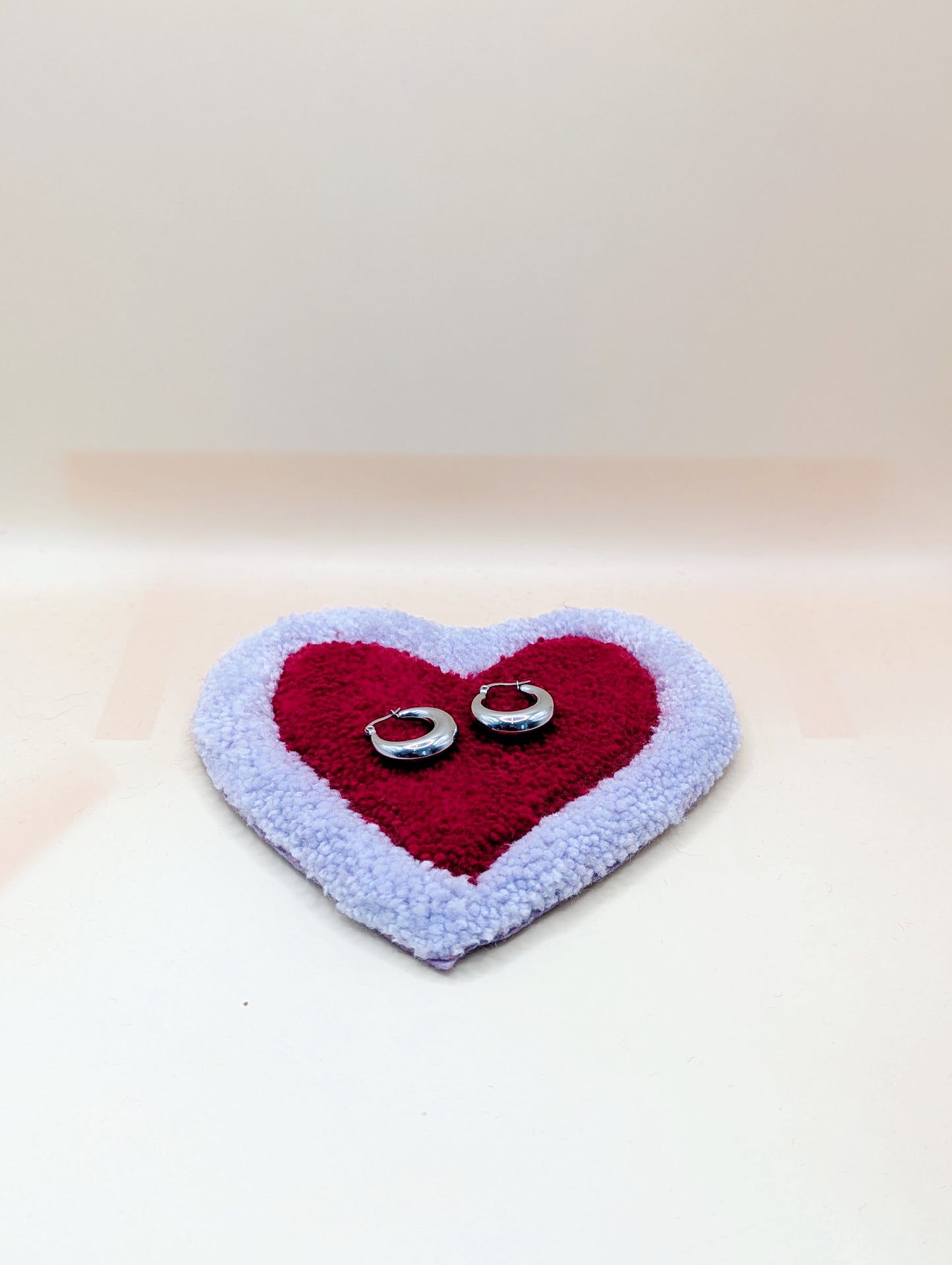 Soft tufted purple and red heart shaped mini rug/coaster 