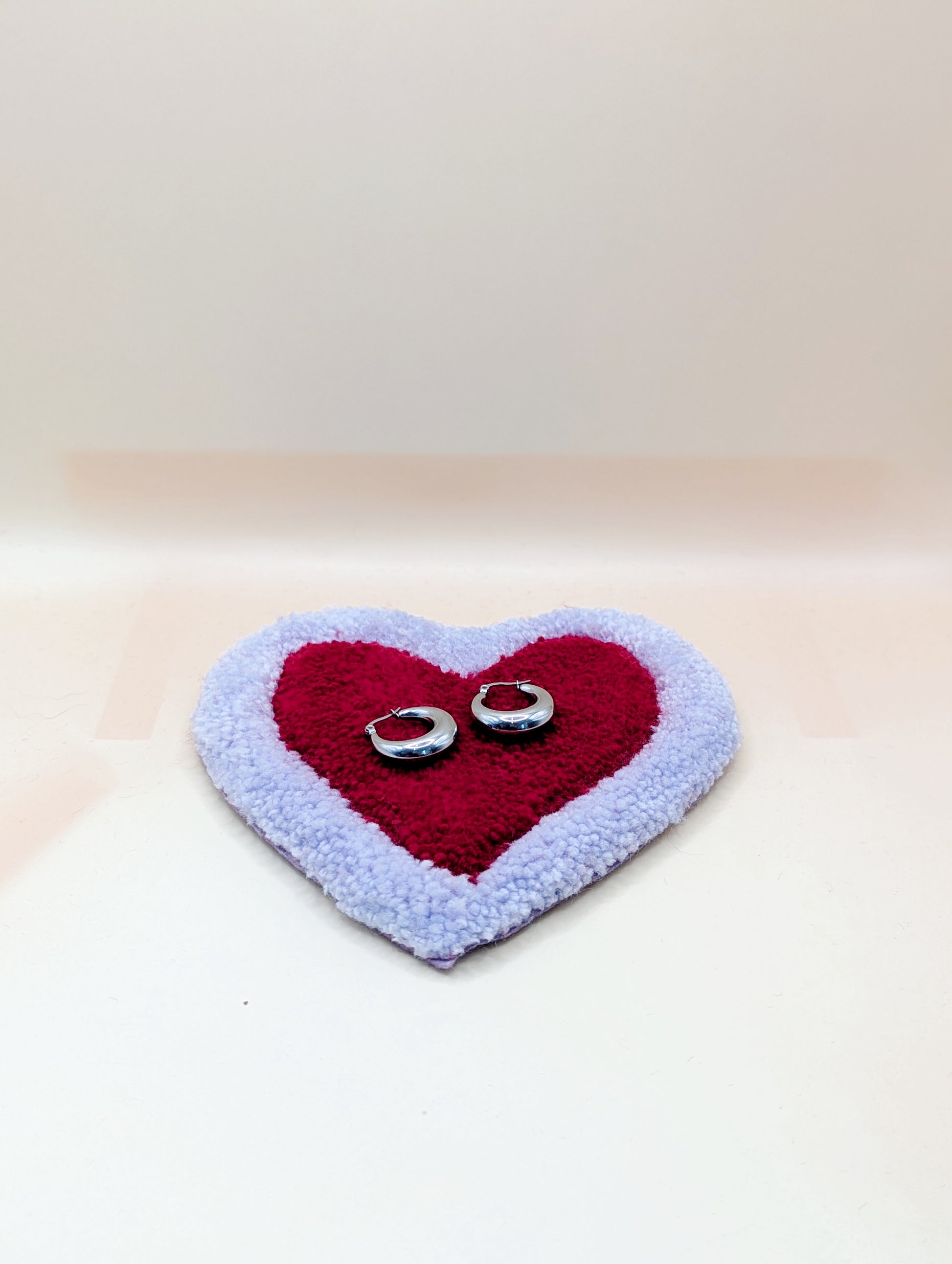 Soft tufted purple and red heart shaped mini rug/coaster 