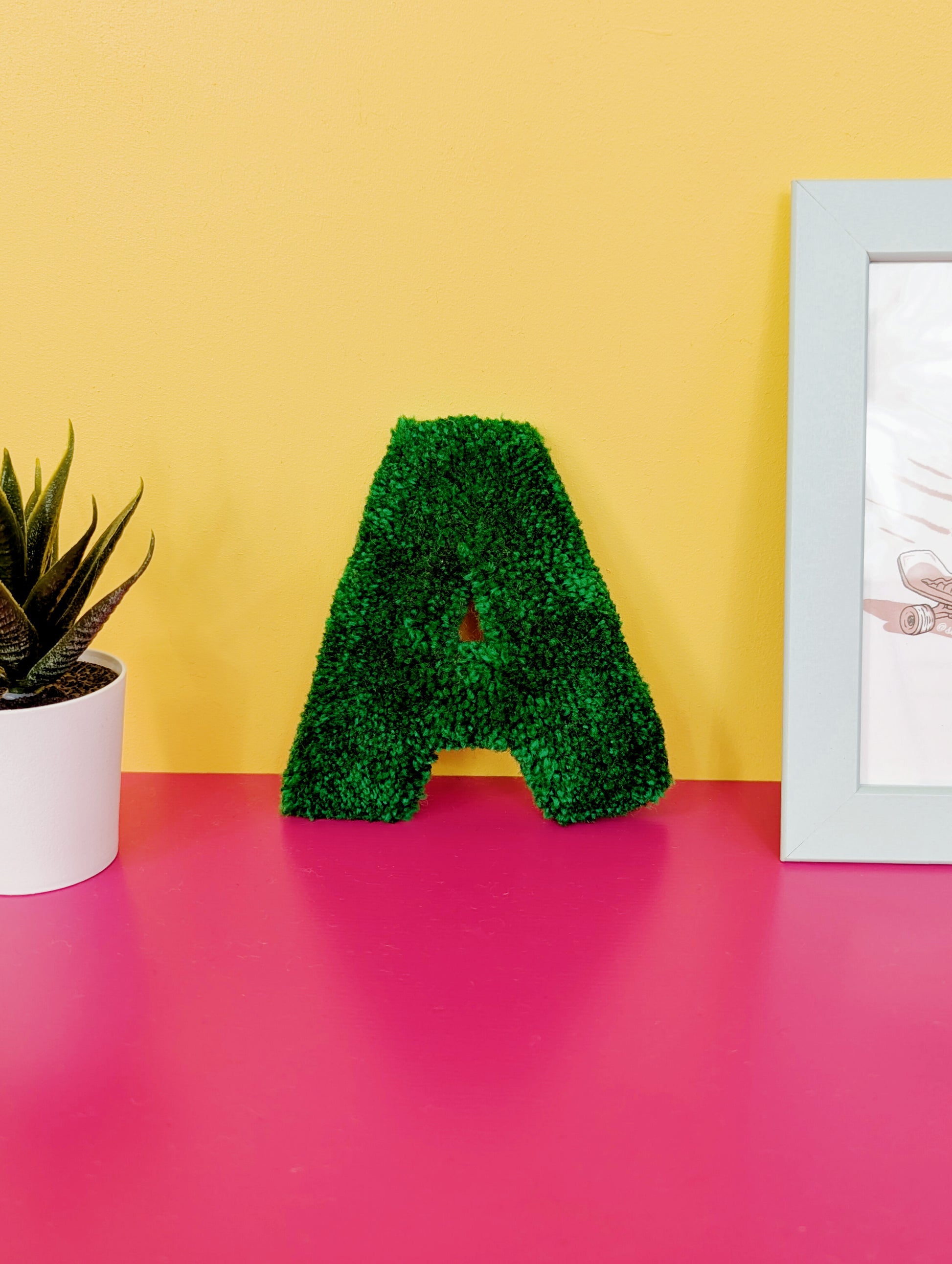 Soft tufted green letter A with metal hook for easy hanging