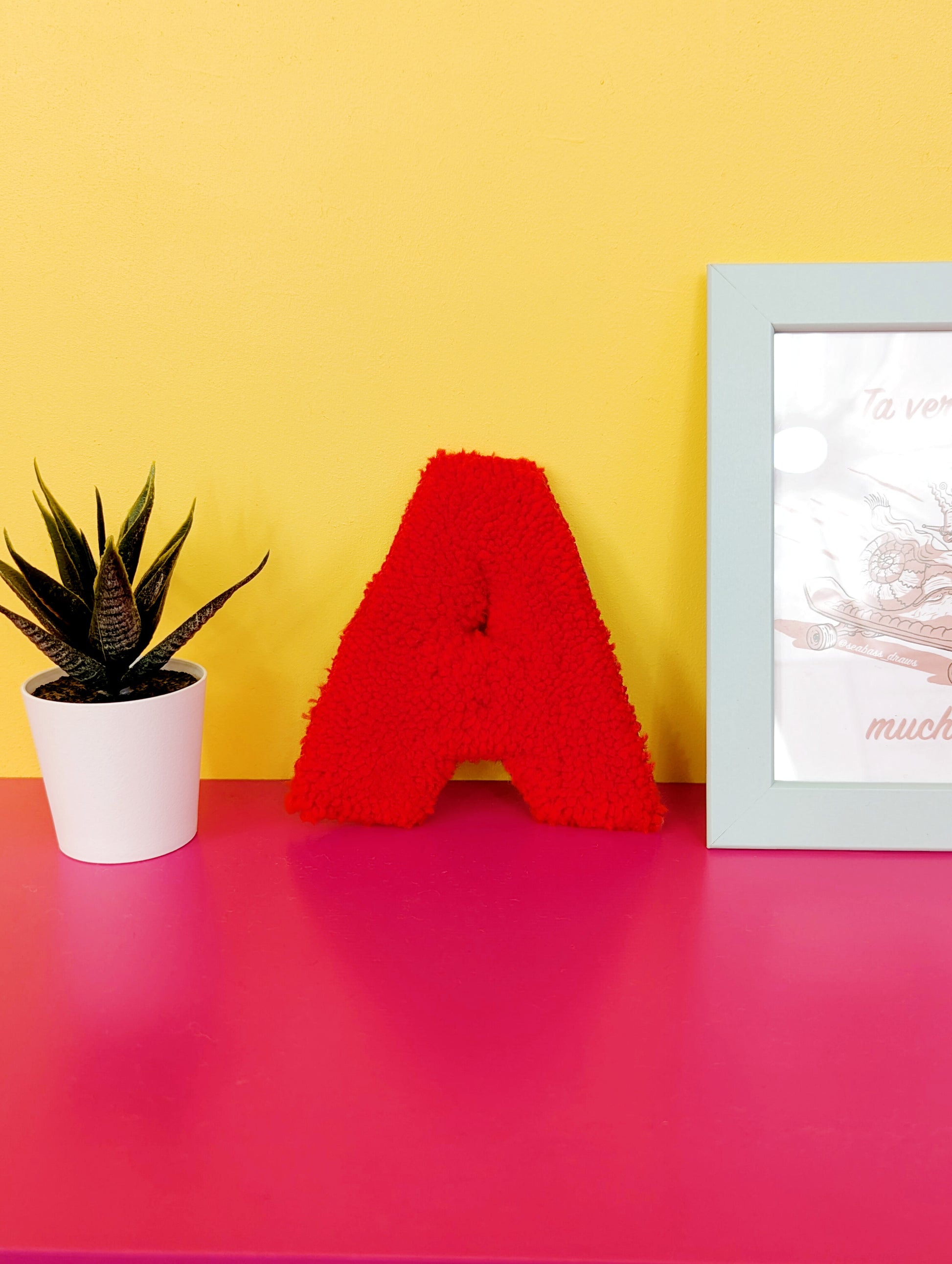 Soft tufted red letter A with metal hook for easy hanging