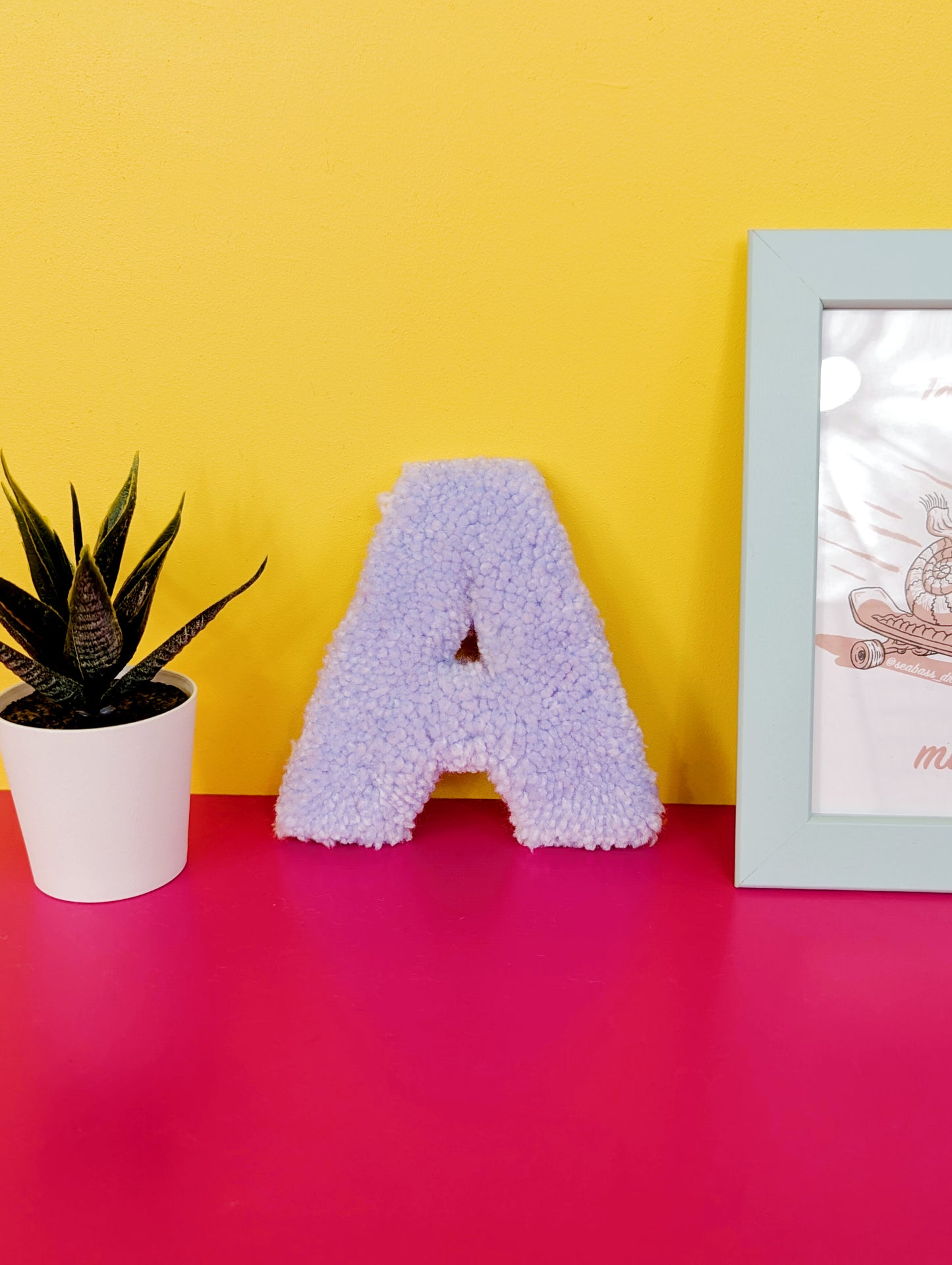 Soft tufted light purple letter A with metal hook for easy hanging