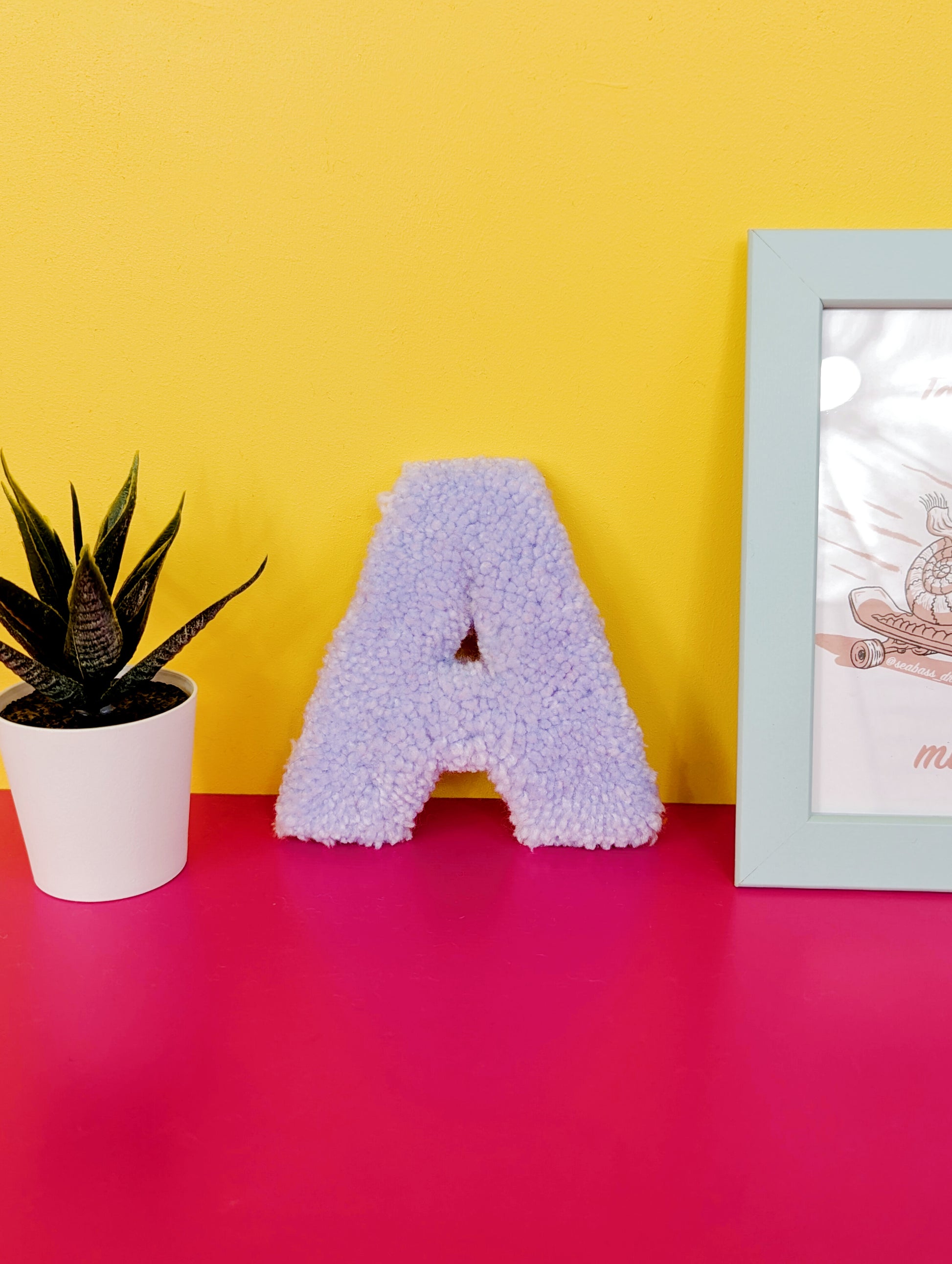 Soft tufted light purple letter A with metal hook for easy hanging