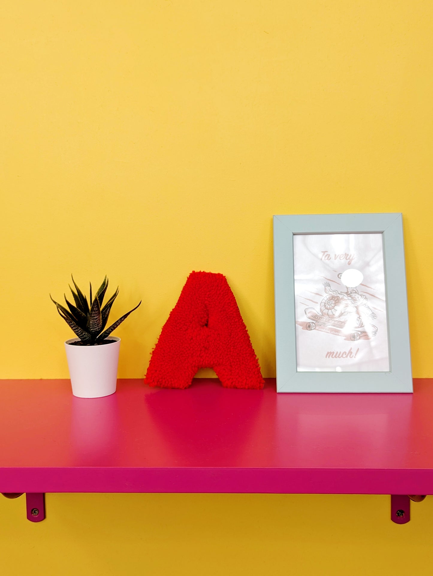 Soft tufted red letter A with metal hook for easy hanging